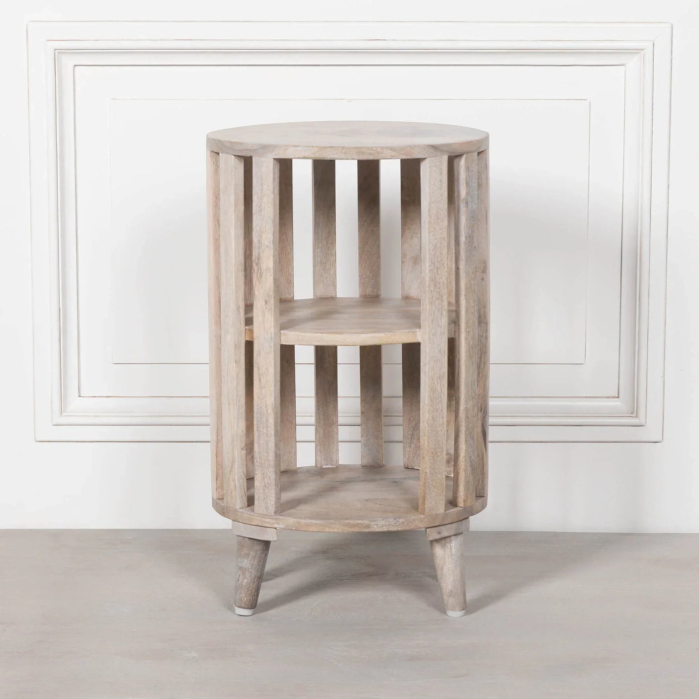 Round wooden side table with slatted sides and two shelves, light natural wood finish