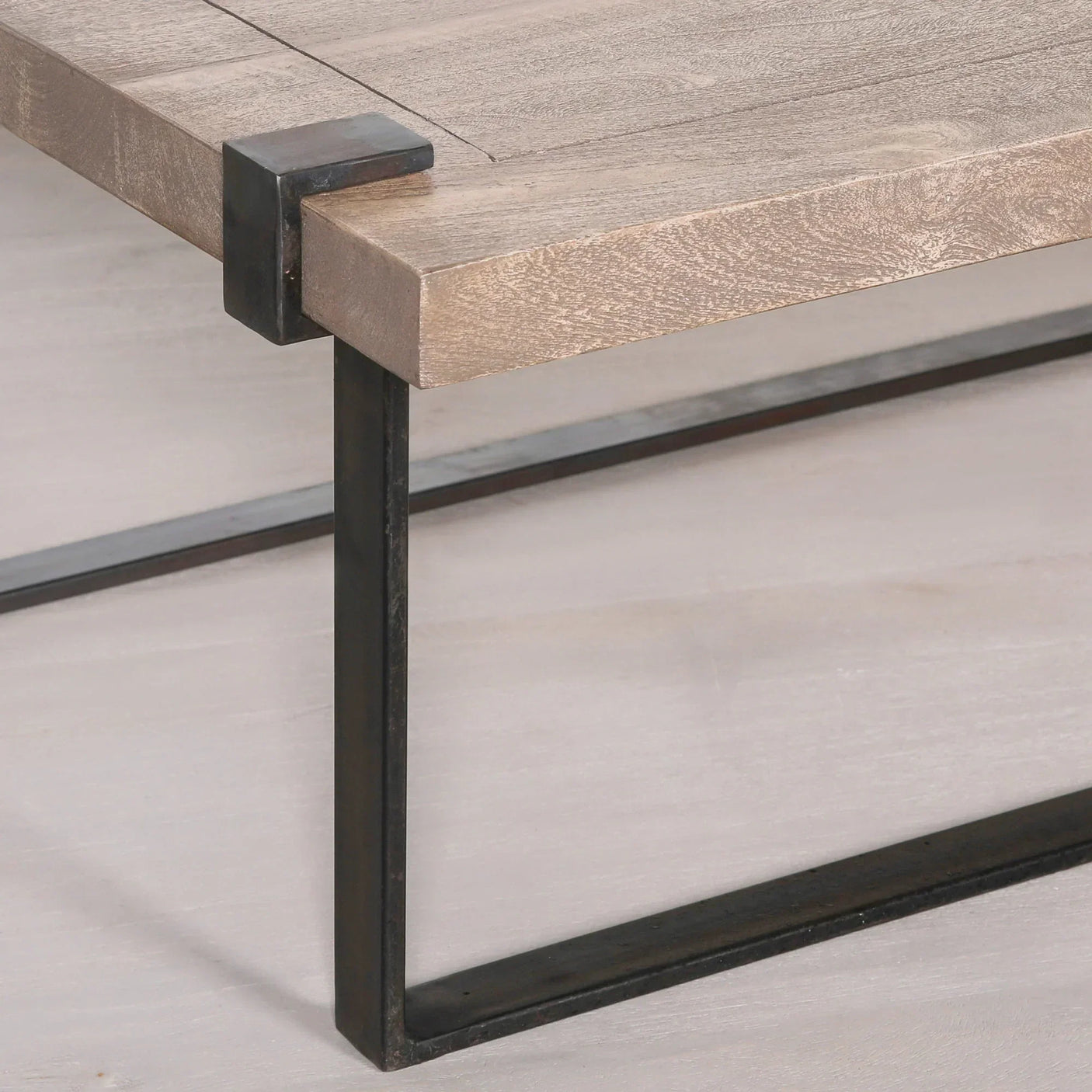 Wooden coffee table with metal frame and corner detail, close-up of leg and tabletop