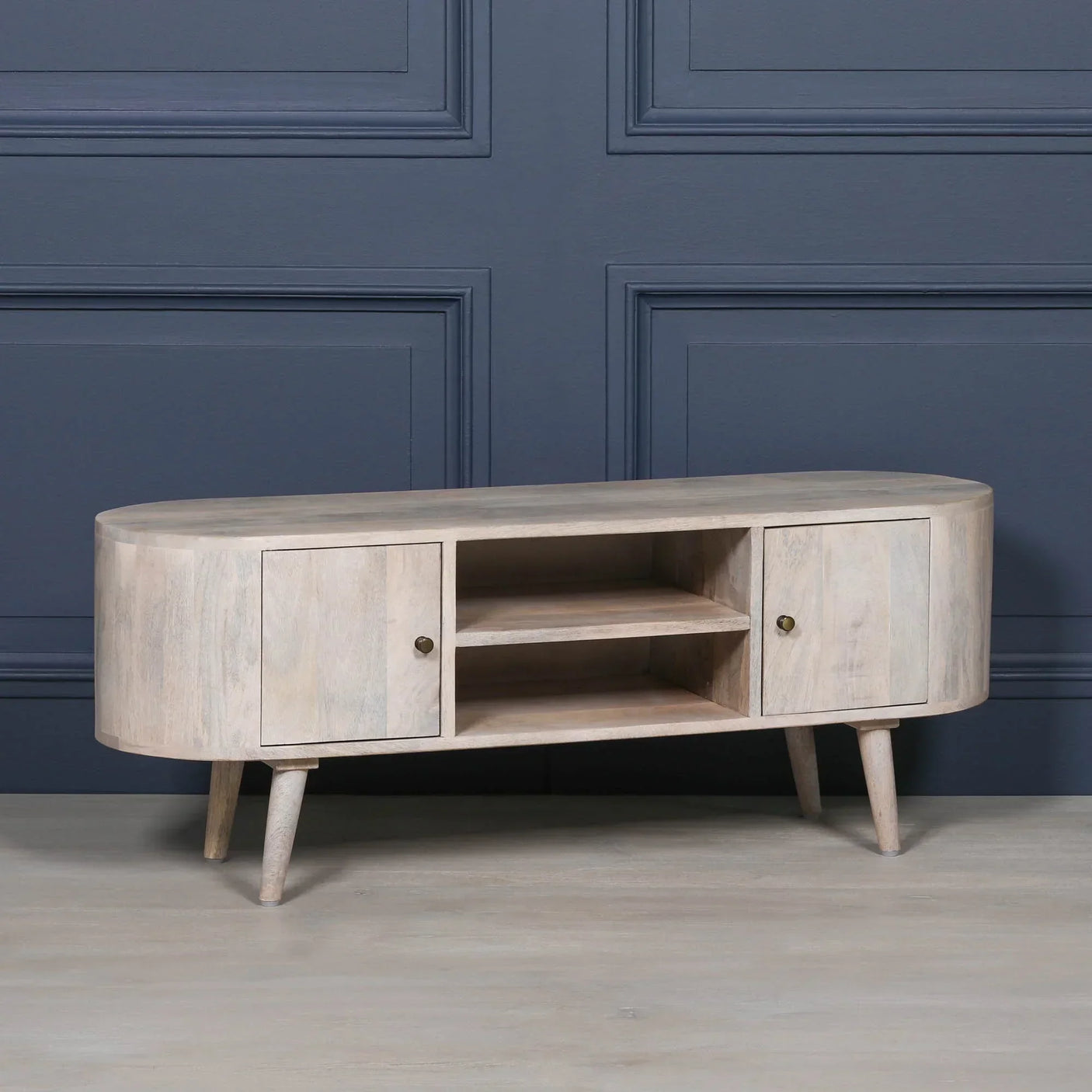 Light wood TV unit with two cabinets, open shelves, rounded corners and angled legs