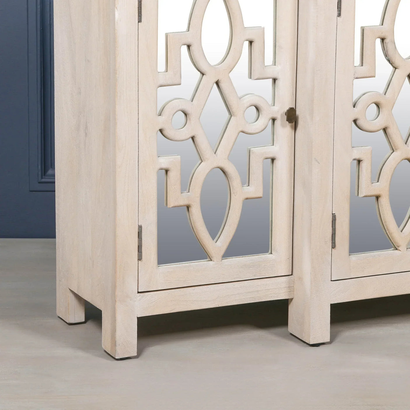 Light wood sideboard cabinet with carved mirrored doors and geometric detailing