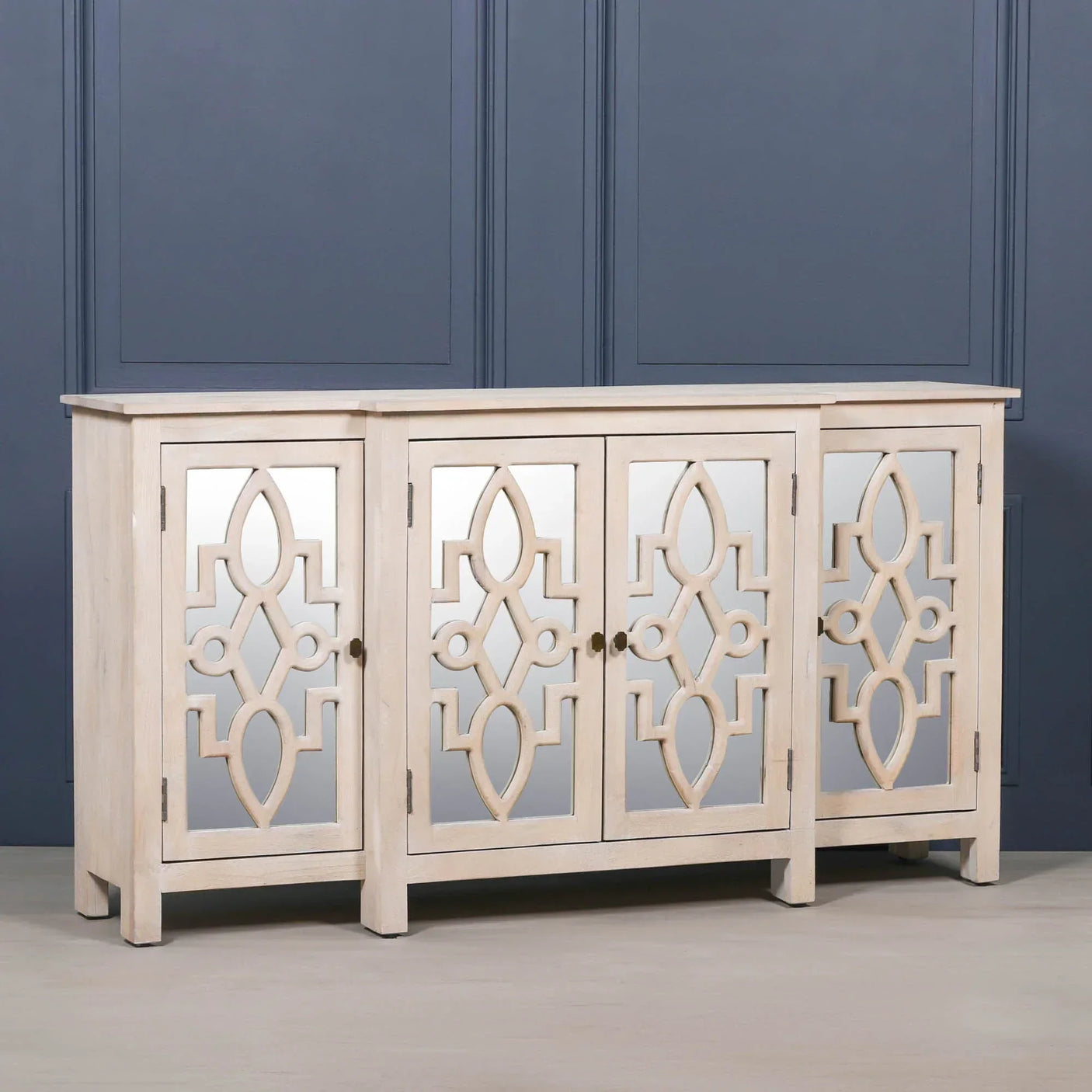 Beige wood sideboard with mirrored cabinet doors featuring geometric lattice design