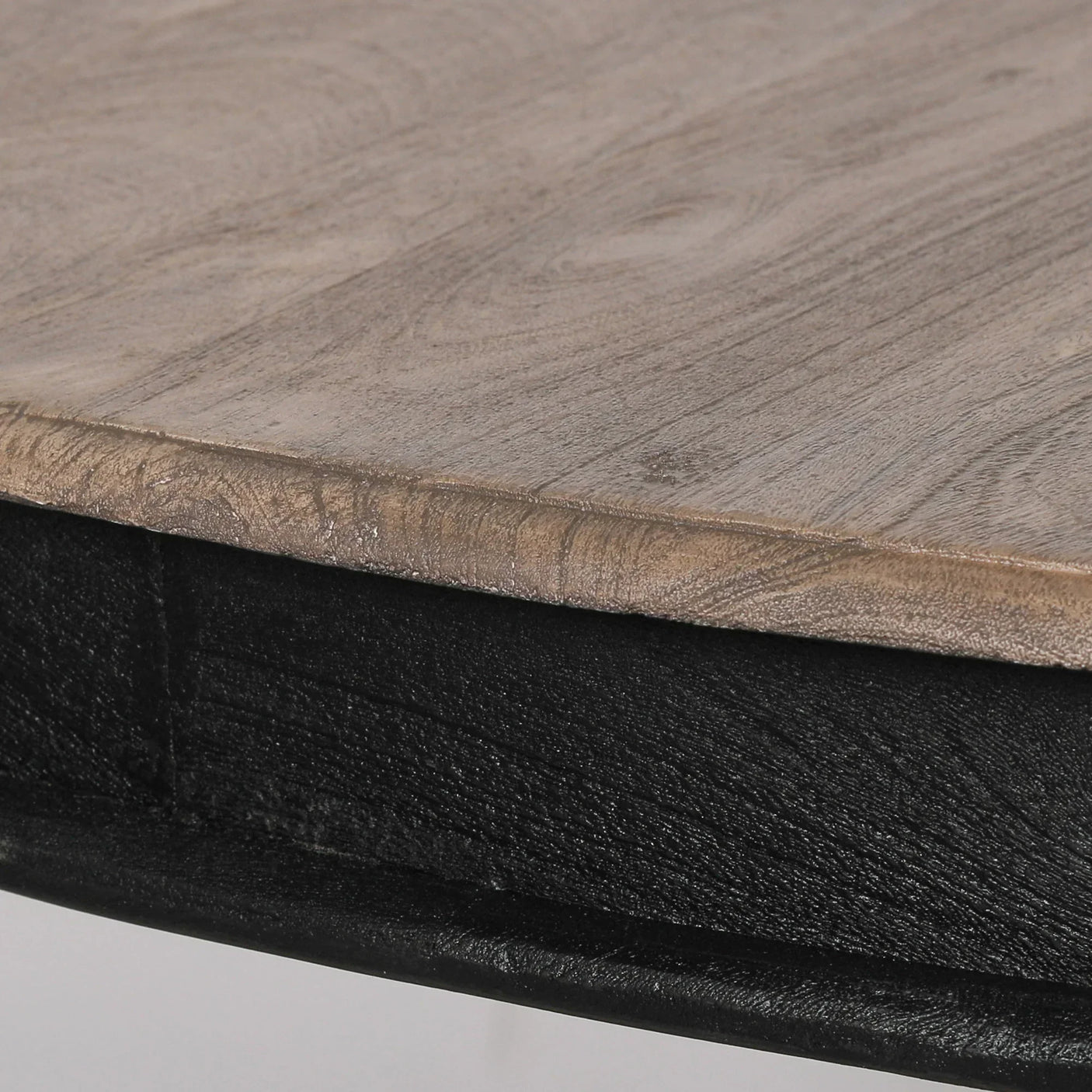 Closeup of wooden table top with black metal edge detail
