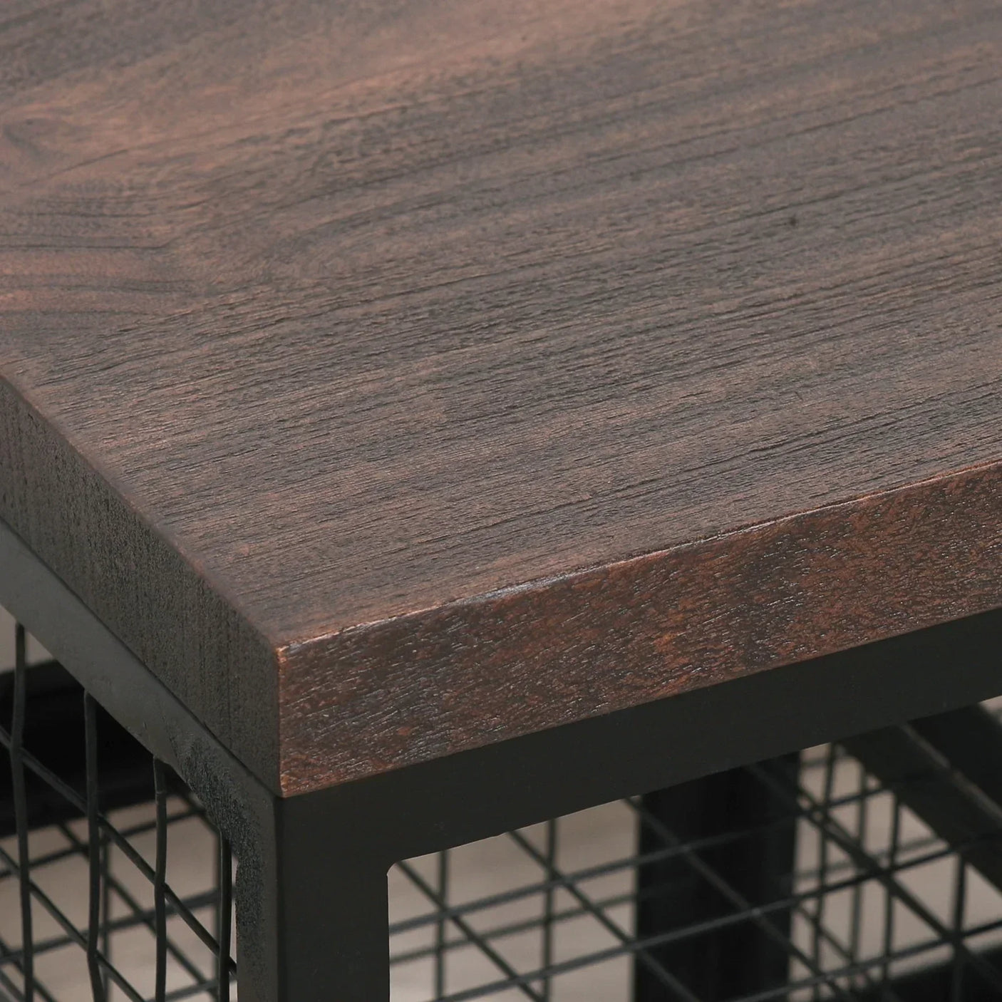 Dark wood coffee table corner with black metal grid base