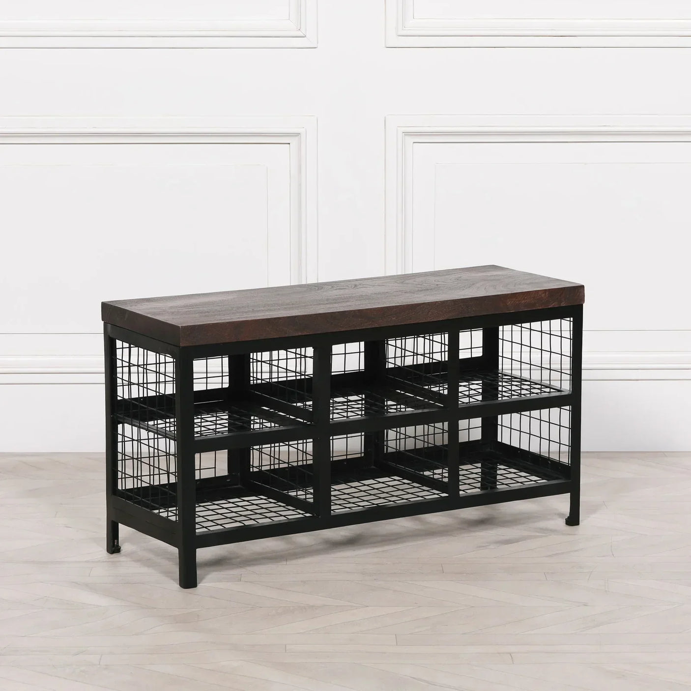 Industrial shoe bench with dark wooden top and black metal wire storage shelves