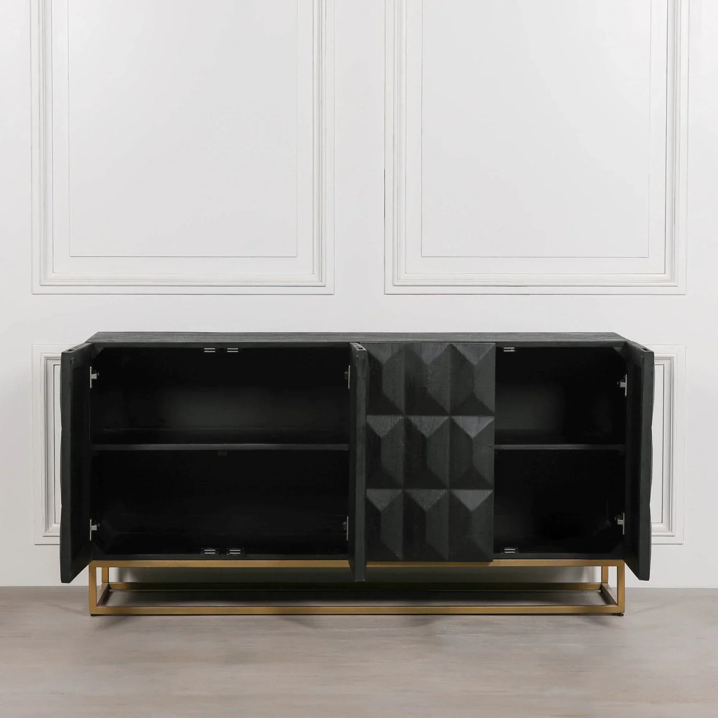 Black sideboard cabinet with geometric doors and gold base, open to show interior shelves