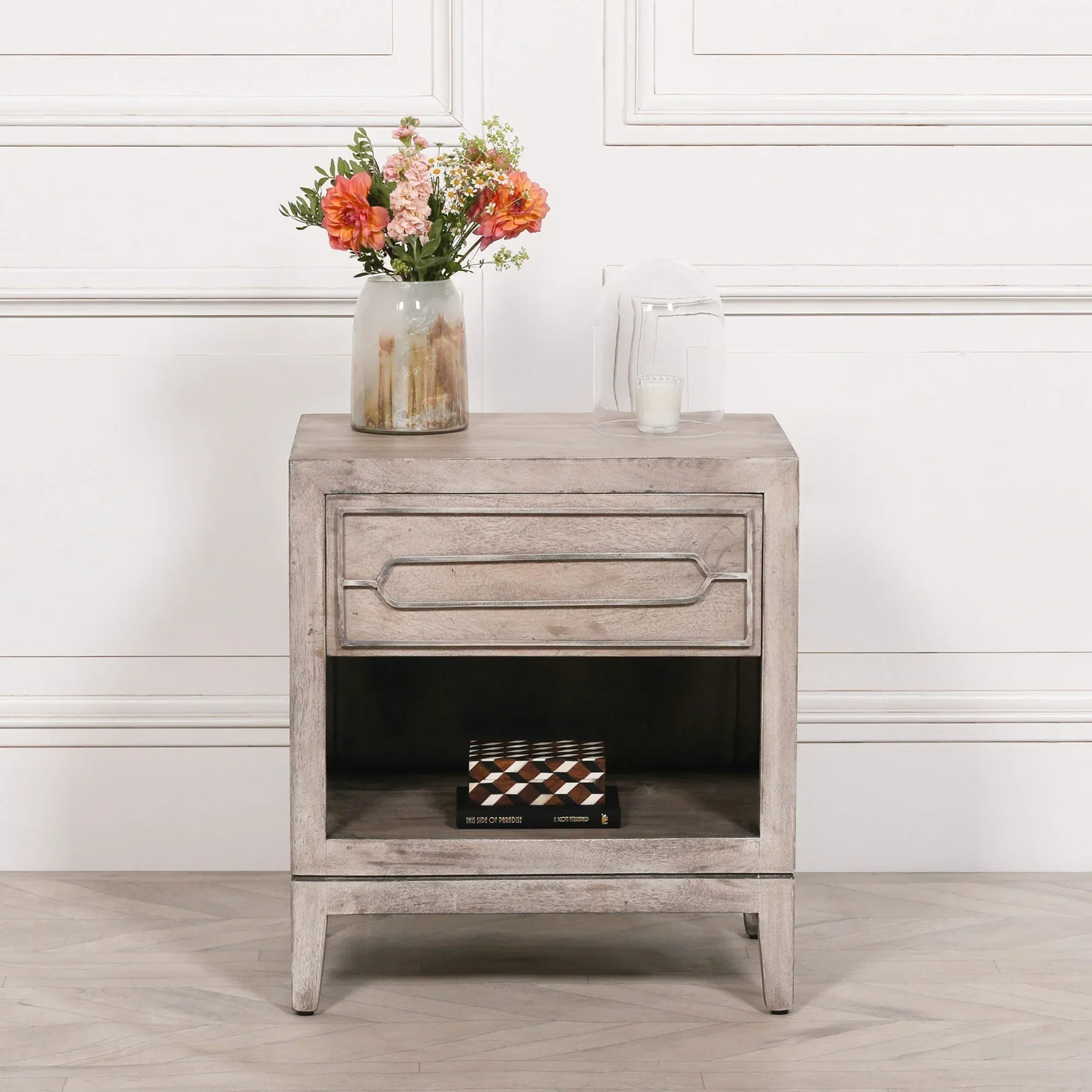 Rustic wood bedside table with drawer and open shelf, vase of flowers on top