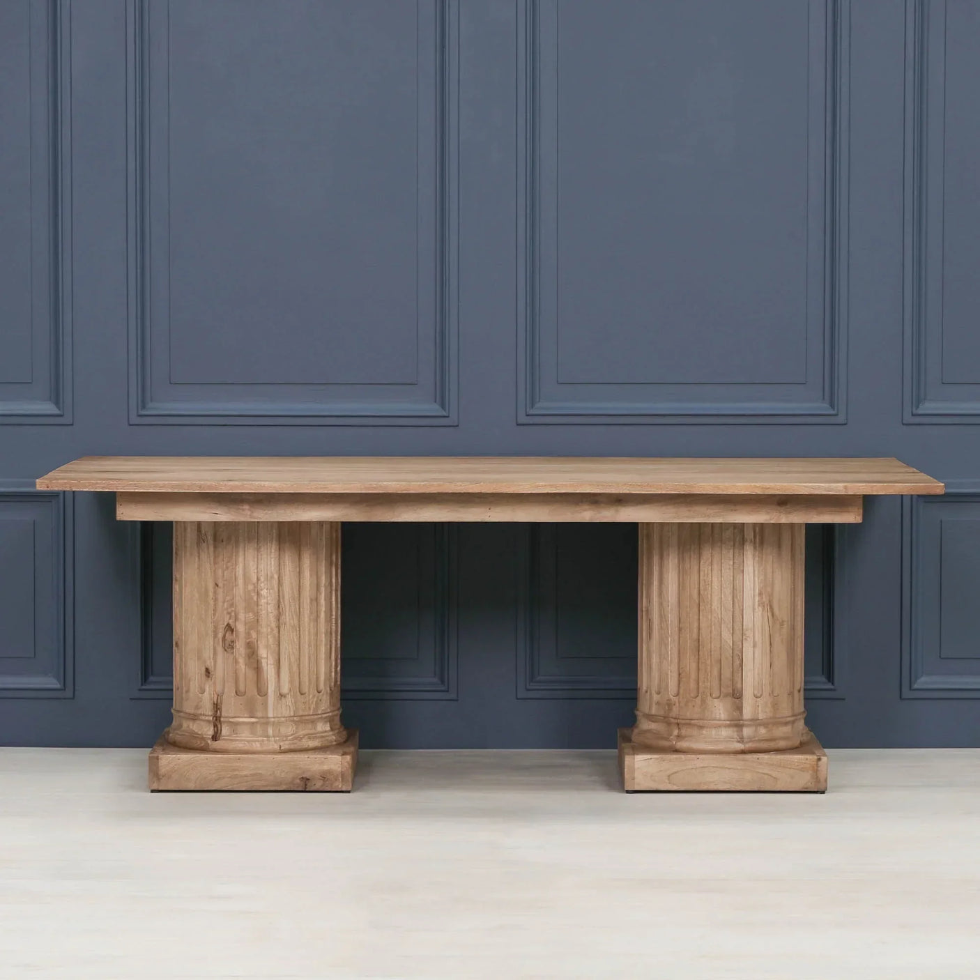 Solid wood dining table with twin pedestal bases and fluted column design