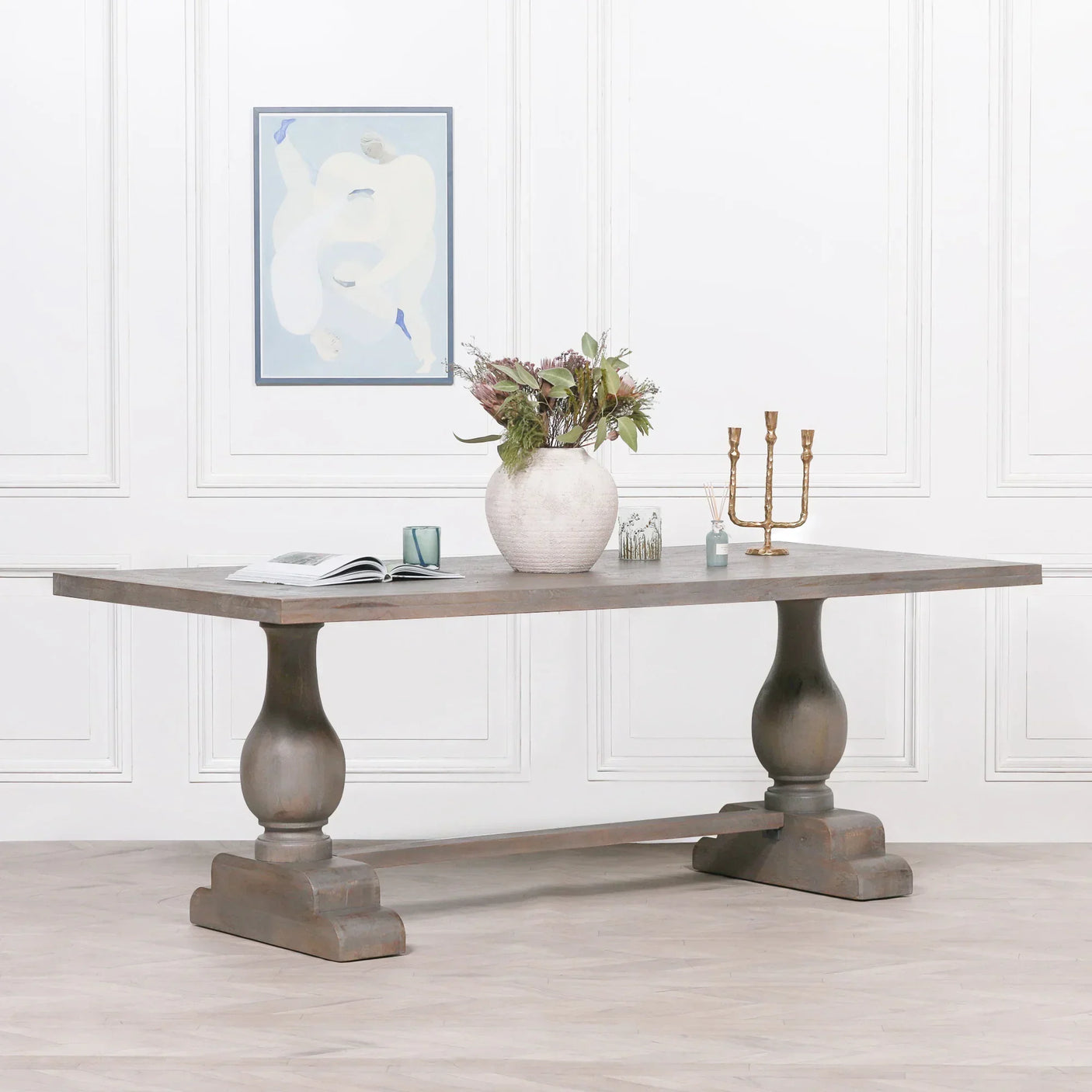 Rectangular wooden dining table with turned pedestal legs and decorative tabletop accents
