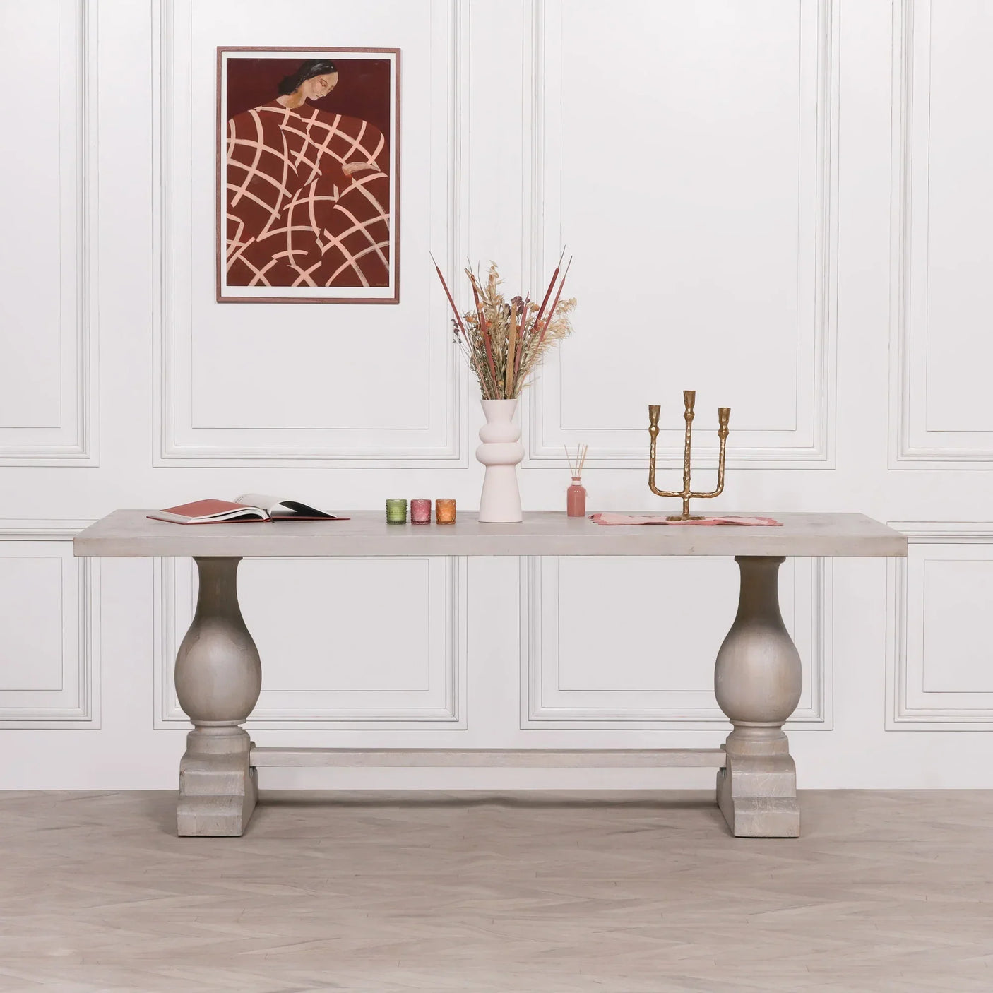 Rectangular dining table with light wood finish, turned legs, and decorative tabletop accents
