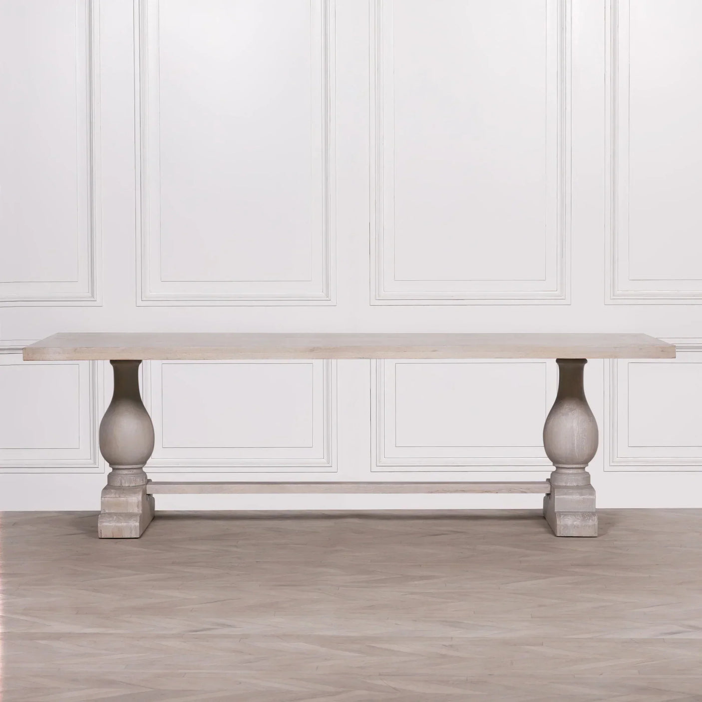 Rectangular wooden dining table with thick turned legs and light oak finish