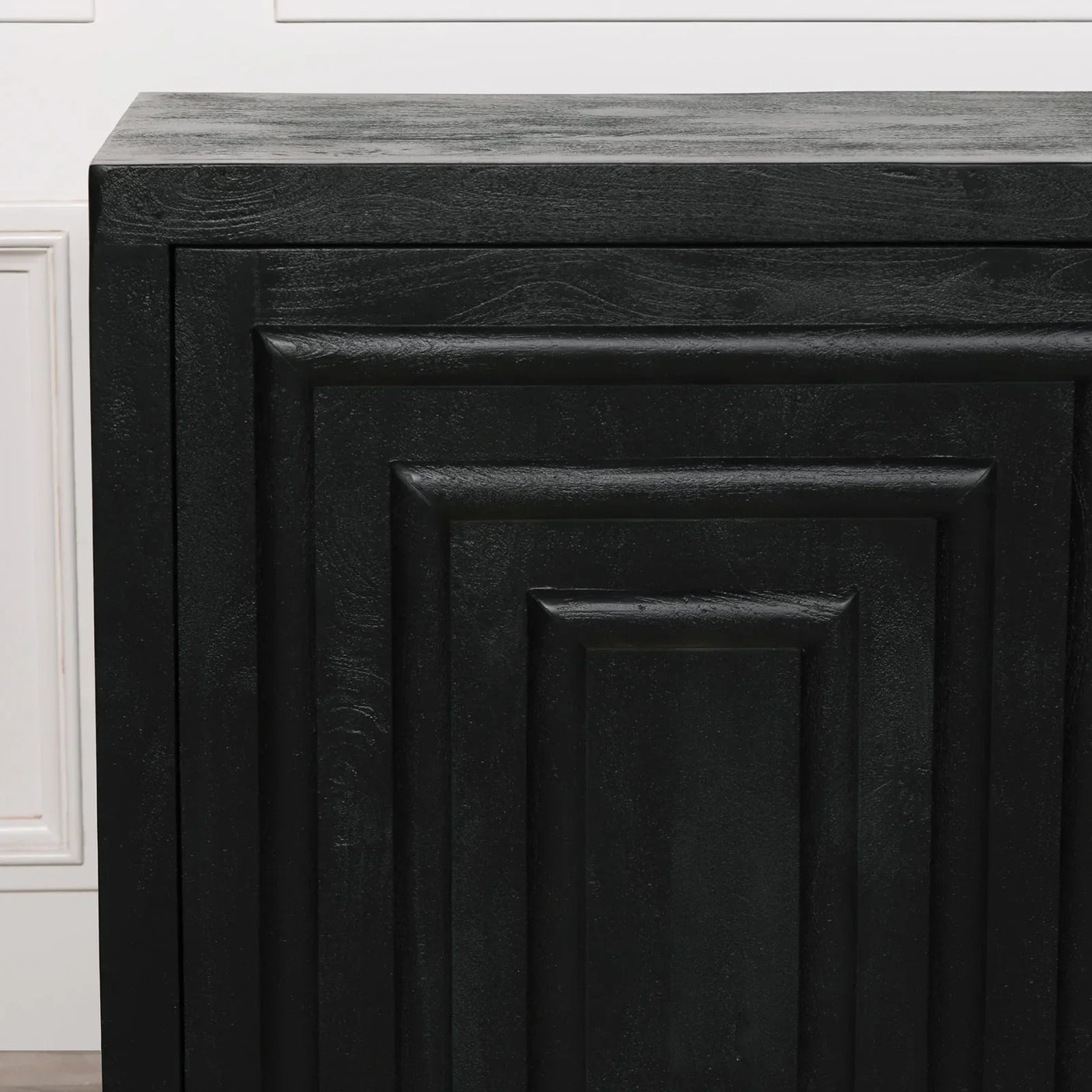 Black sideboard cabinet with textured geometric panel and wood grain detail close-up