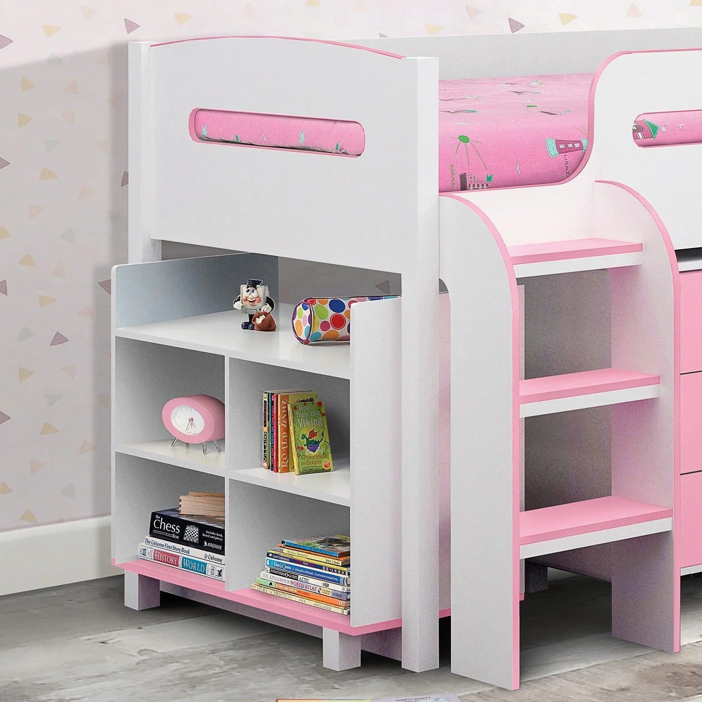 White and pink cabin bed with built-in shelves and pink steps, children's books displayed
