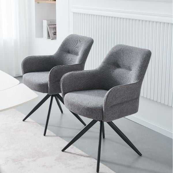 Two modern gray upholstered swivel armchairs with black metal star legs, shown in a bright, contemporary room setting.