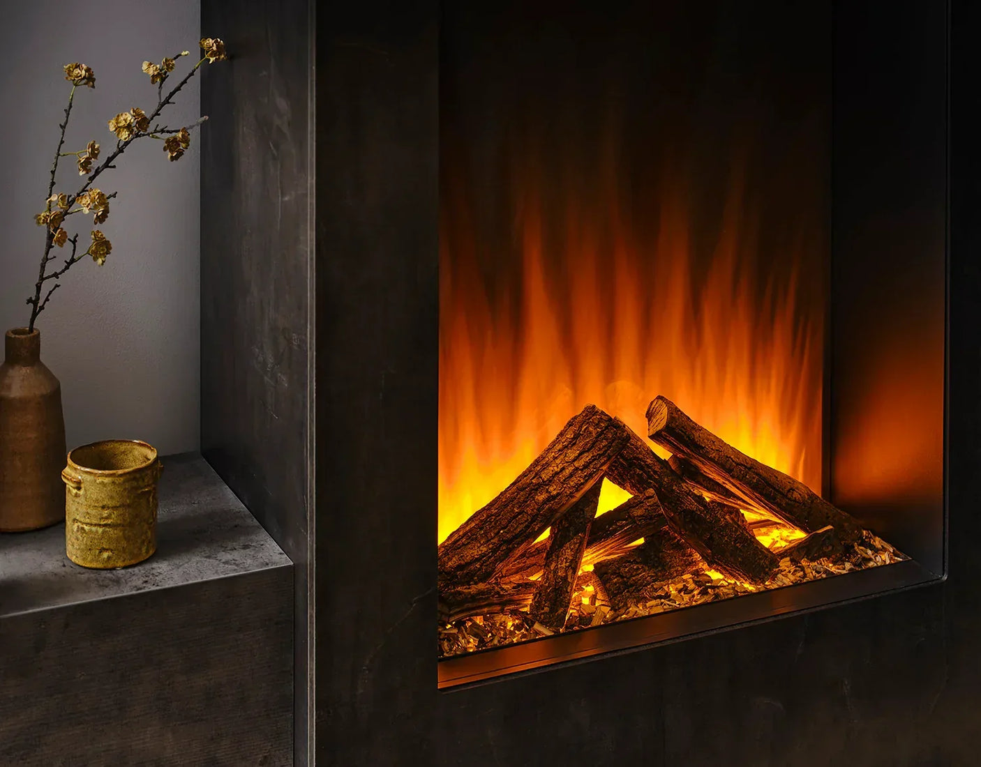 electric fireplace with realistic orange flame effect and log set in dark surround