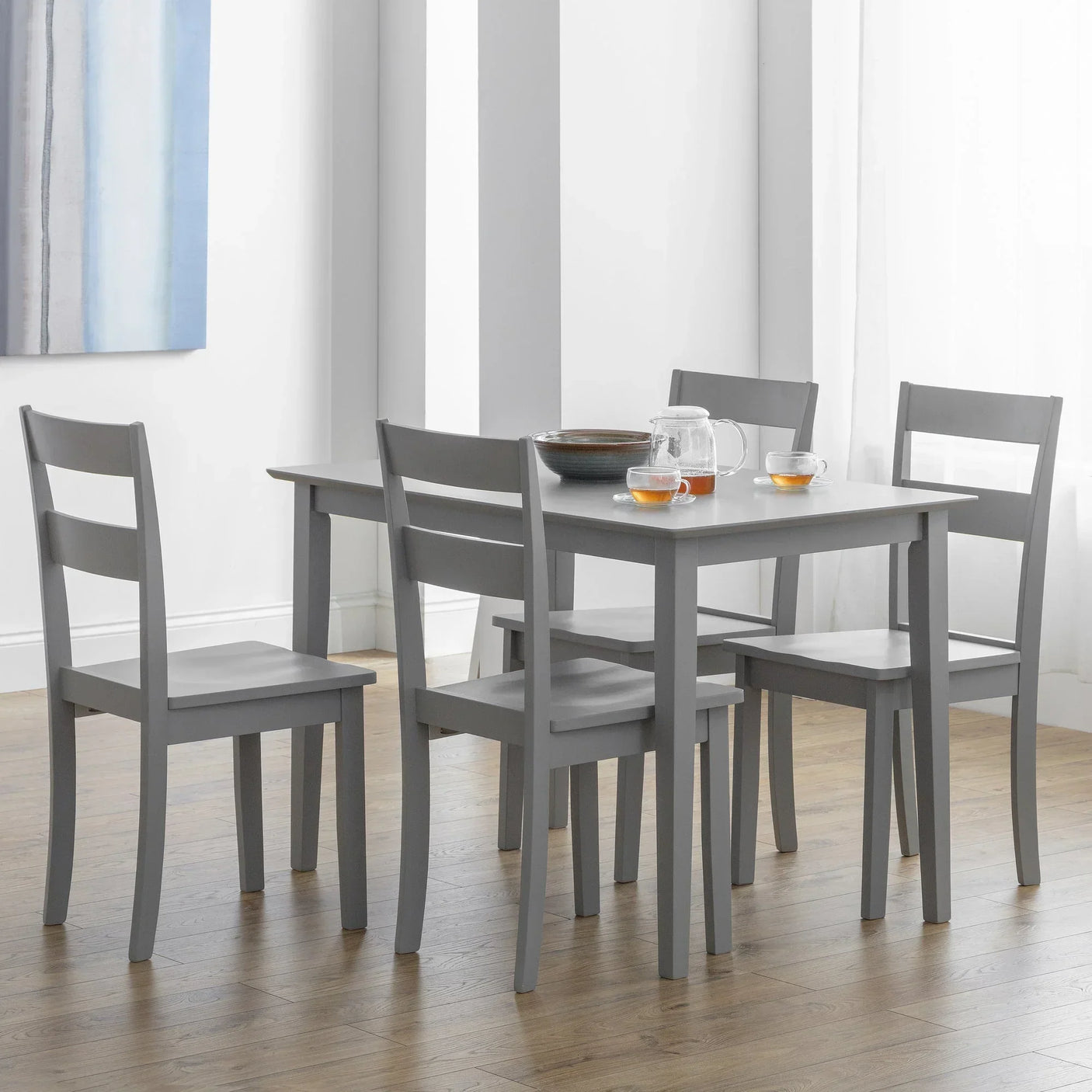 Grey wooden dining table set with four chairs in a modern dining room