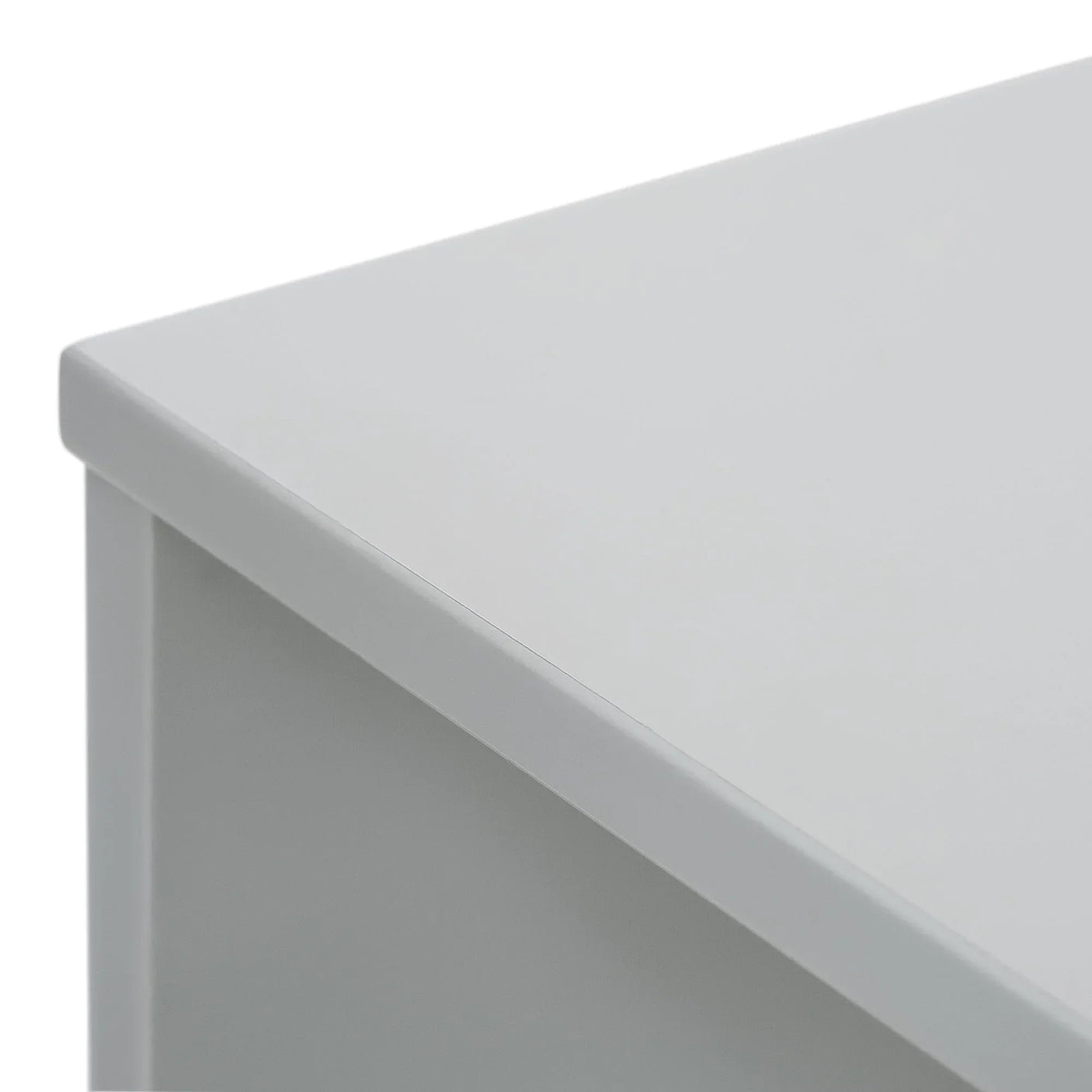 White desk corner with smooth laminate surface and sharp edge detail