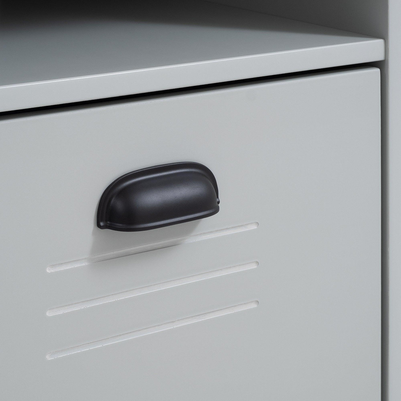 Locker desk storage compartment with matte black handle and horizontal vent detail
