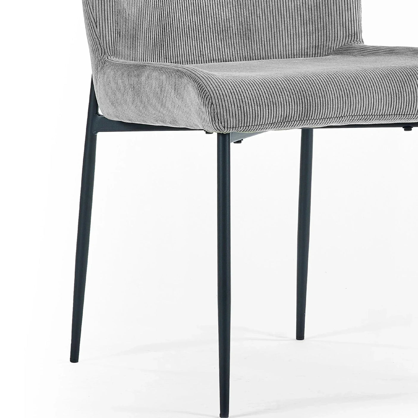 Grey corduroy dining chair with black metal legs, close view of seat and frame