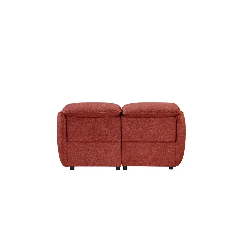 Rear view of two-seater red fabric sofa with plush cushions and compact design