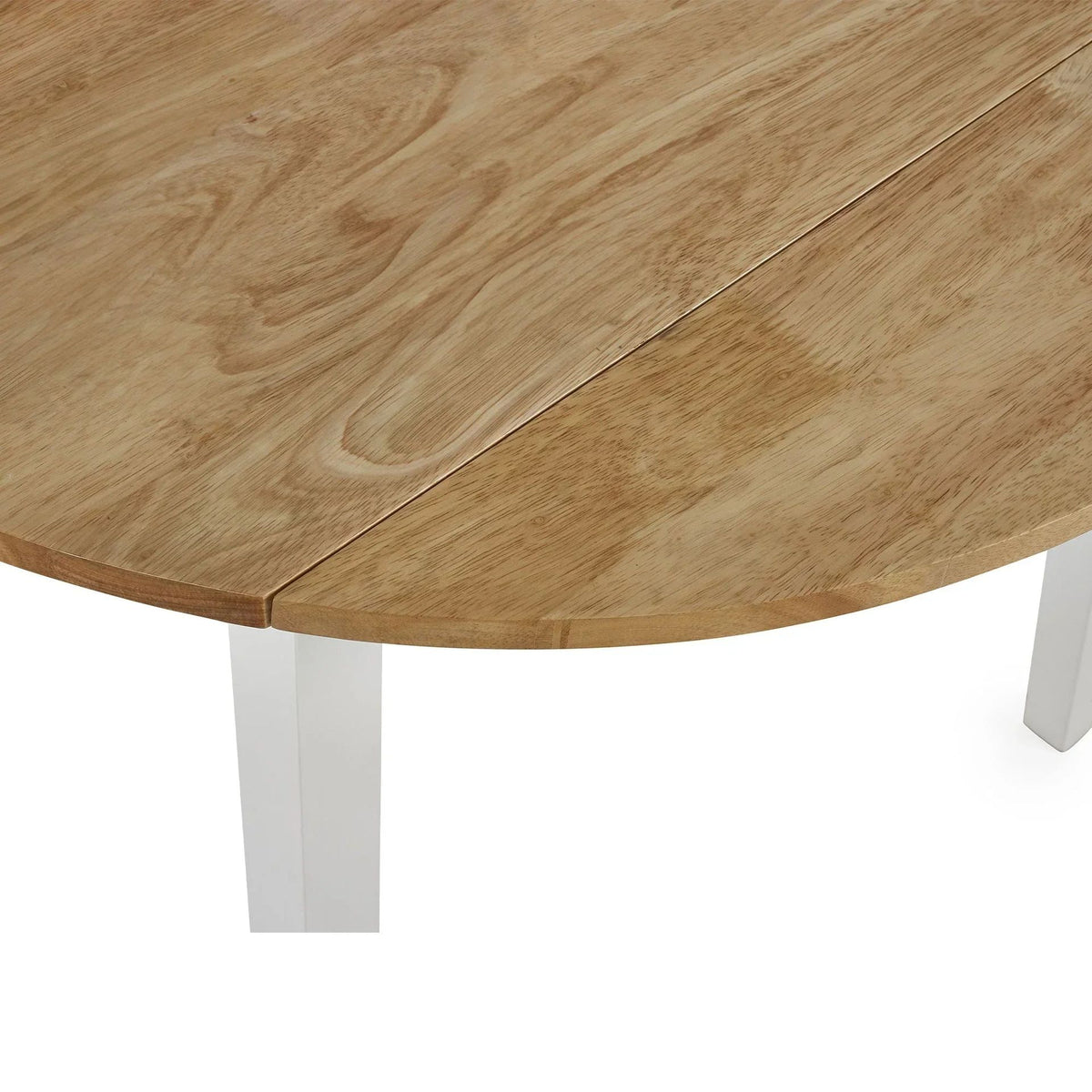 Close-up of round wooden table top showing the drop-leaf joint line, pale wooden leg