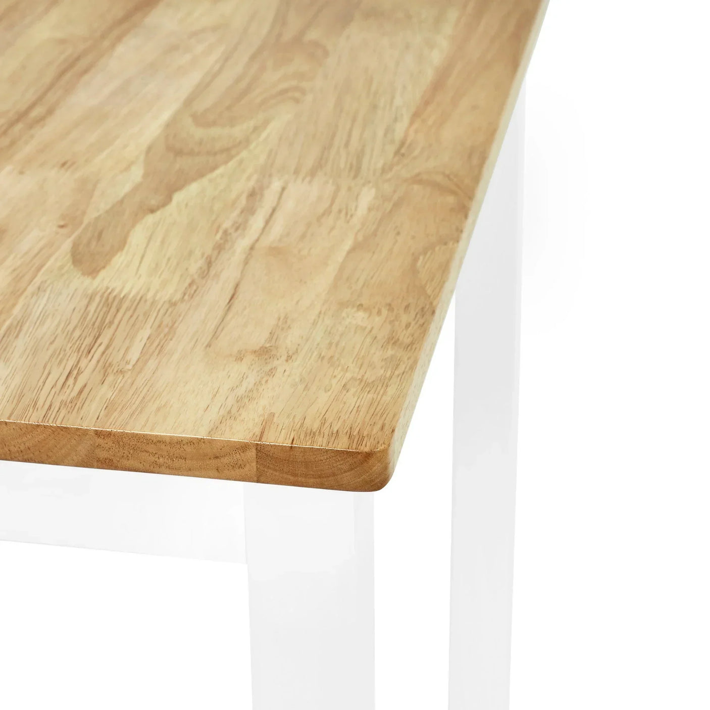 Light wood dining table with white legs, close-up of tabletop corner