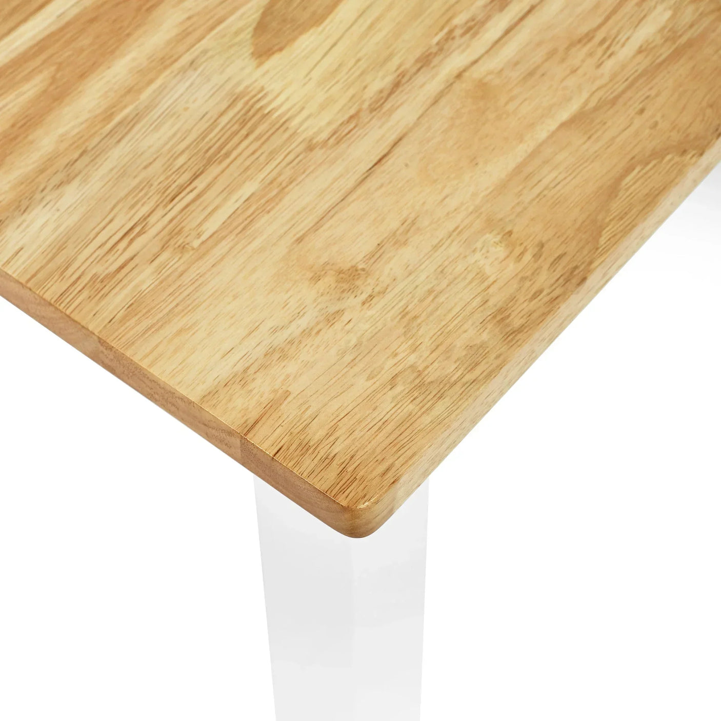 Close view of rectangular wooden dining table top with natural grain and smooth edges