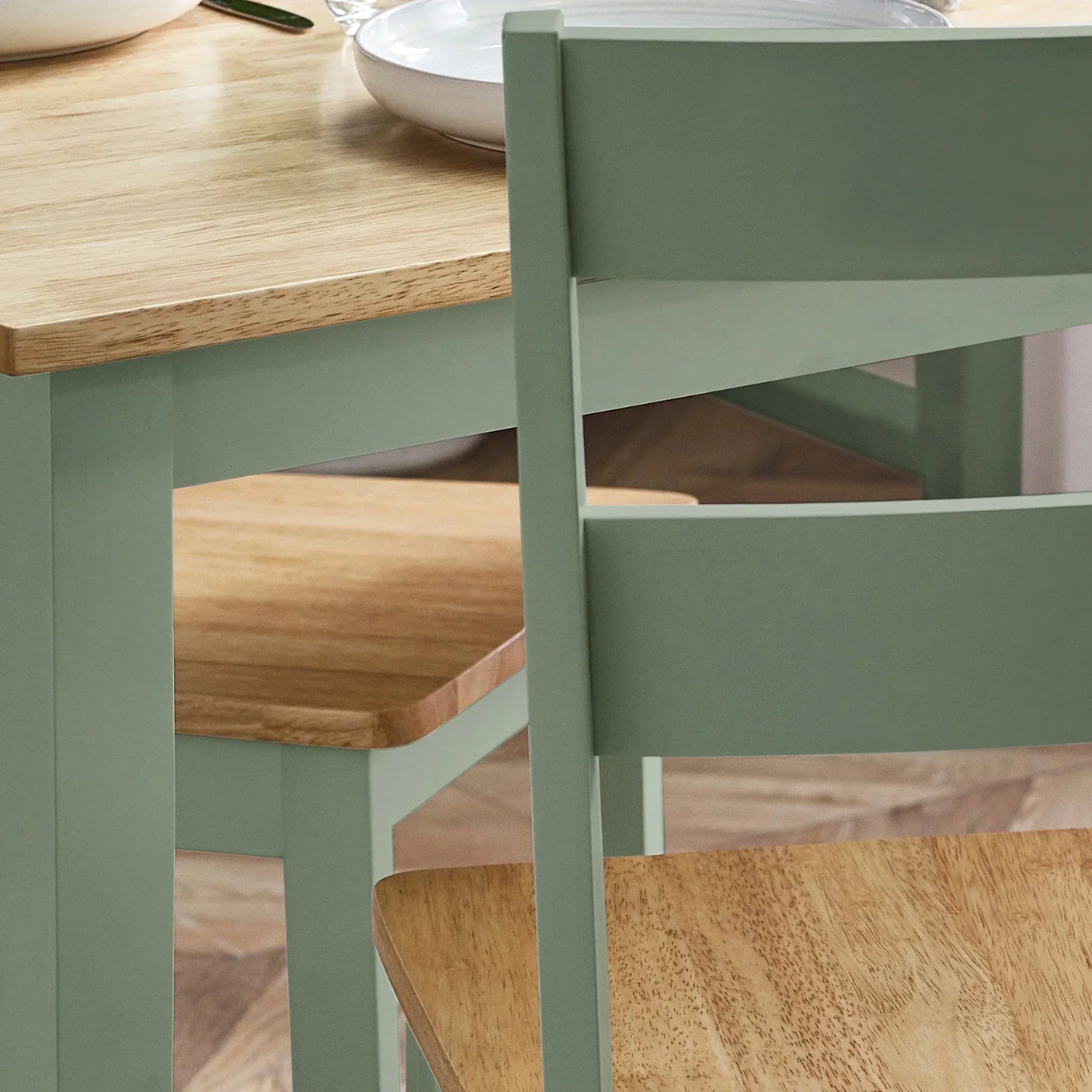 Oak dining table and chair set with sage green painted legs and natural wood tops