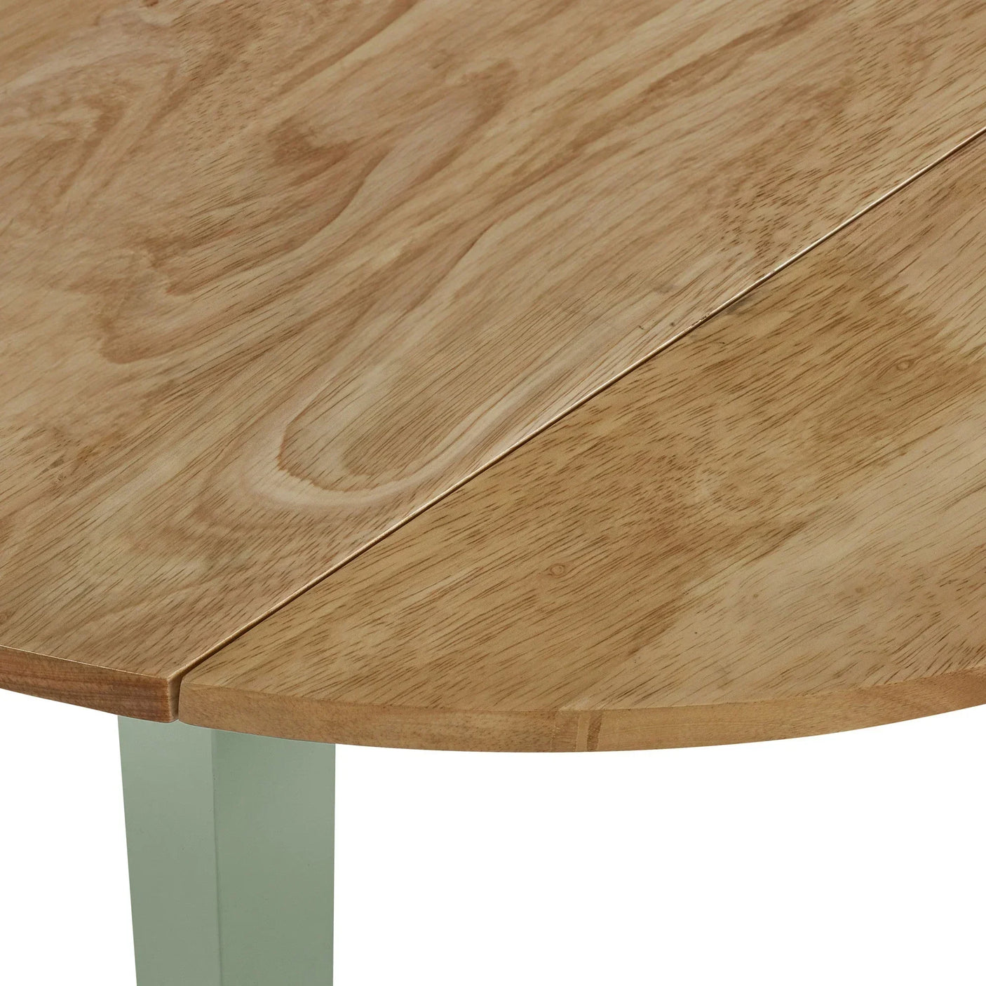 Close-up of natural wood dining table top with visible grain and modern angled edge