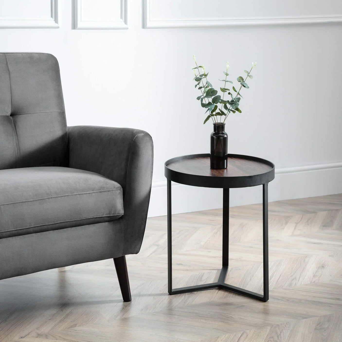 Loft walnut lamp table with black metal frame beside grey sofa on herringbone floor