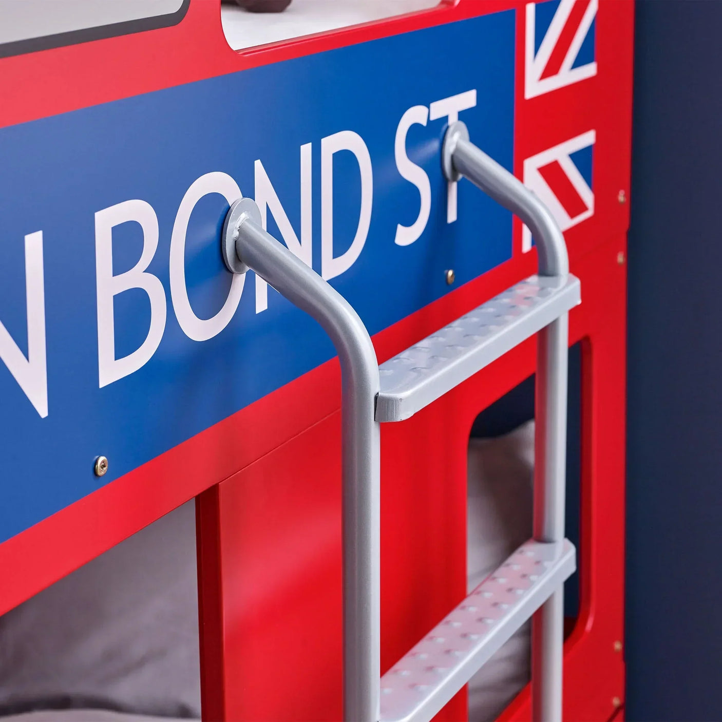Red London bus bunk bed with metal ladder and Union Jack detail