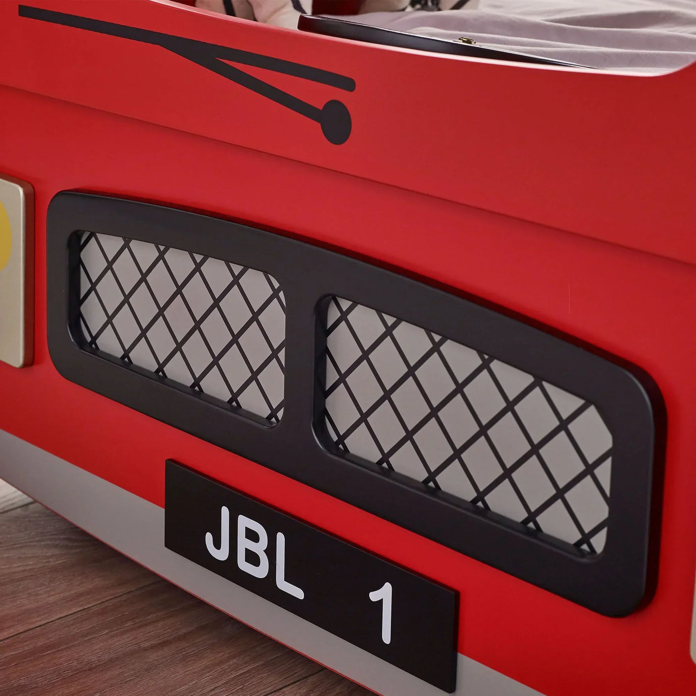 Red London bus bunk bed detail with black mesh panels and license plate design