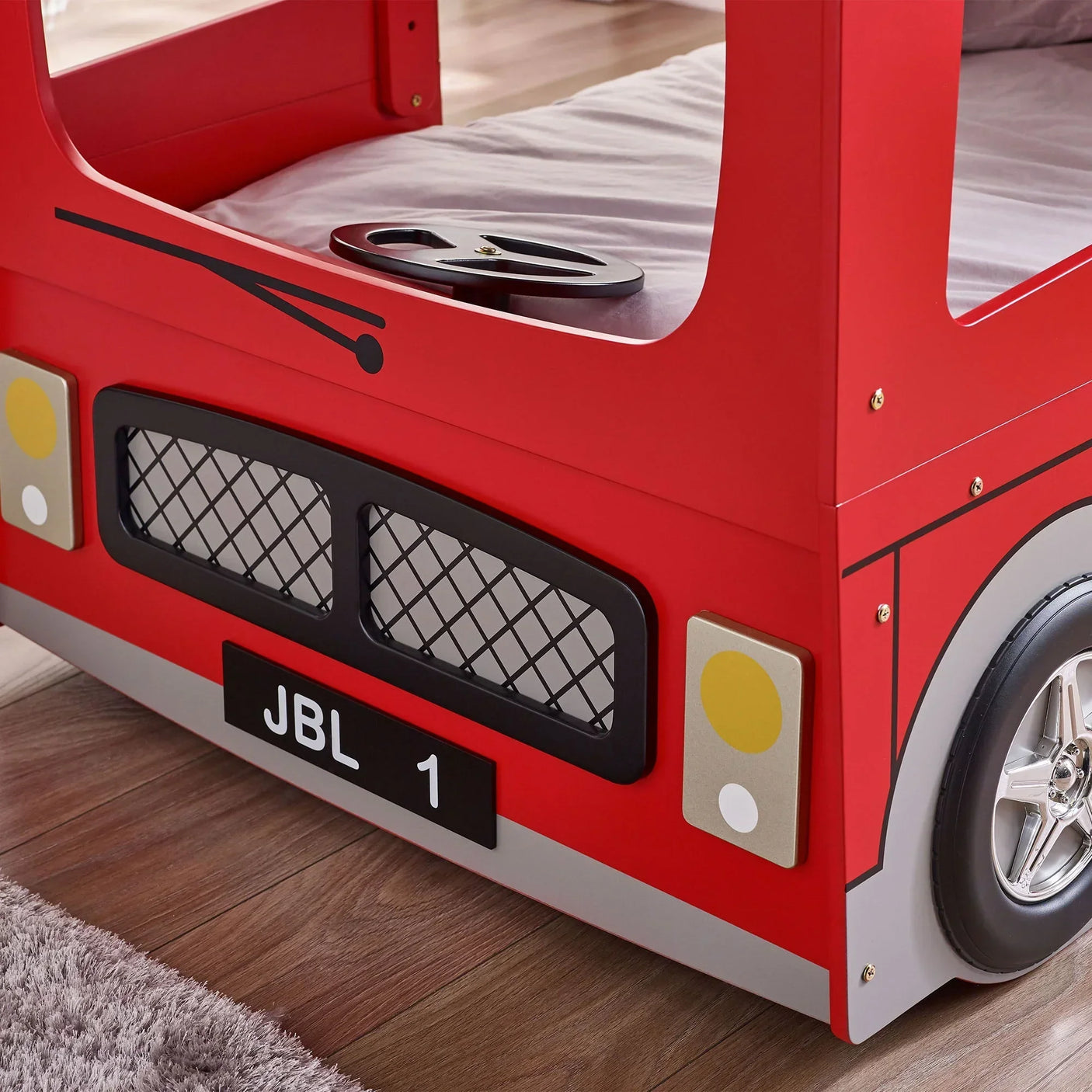 Red London bus bunk bed front panel with black grille, headlights, and silver wheel detail