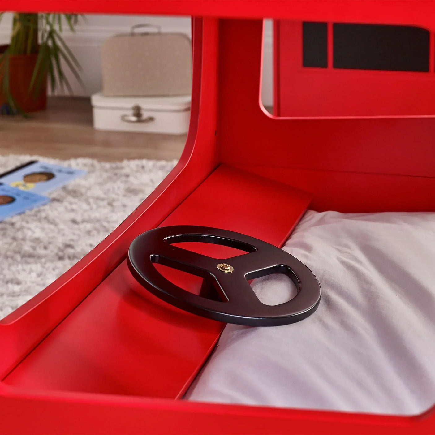London bus bunk bed black steering wheel detail and bedding close-up