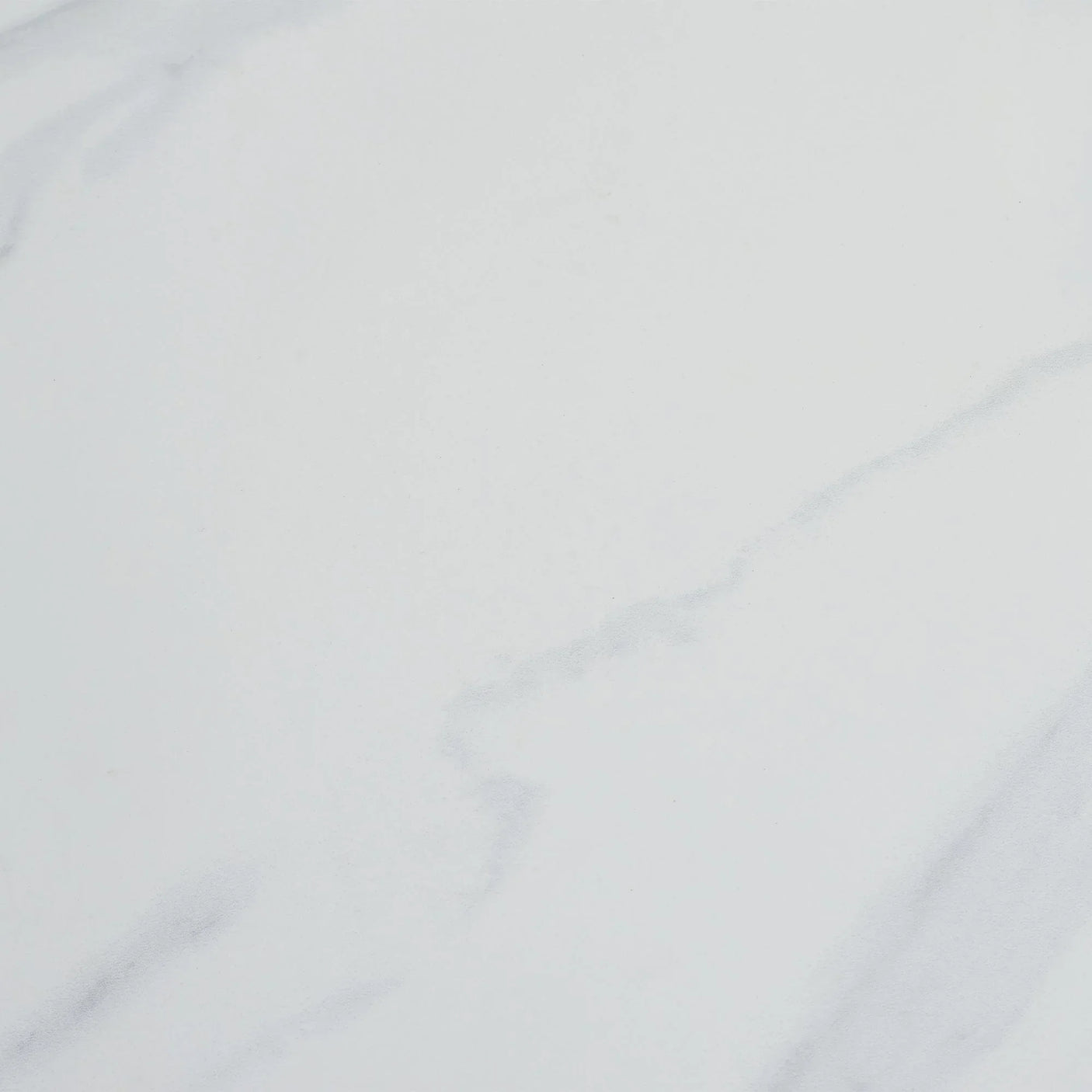 White stone dining table top with subtle grey veining detail, close up view