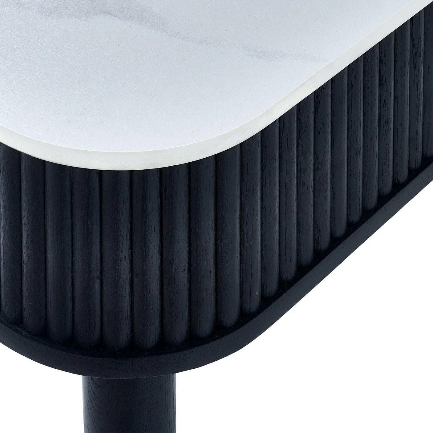 Black fluted dining table corner with white stone top and textured wood detail