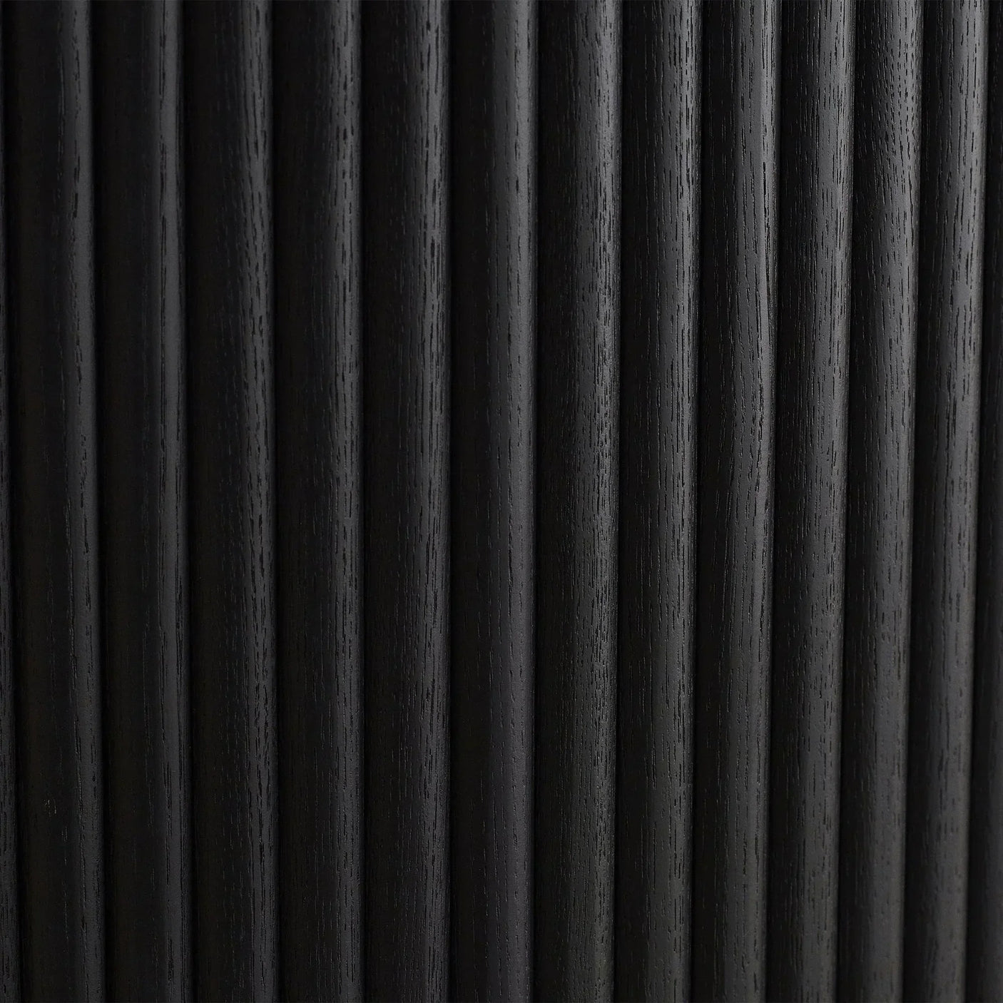 Black fluted wood detail on extending dining table base vertical closeup
