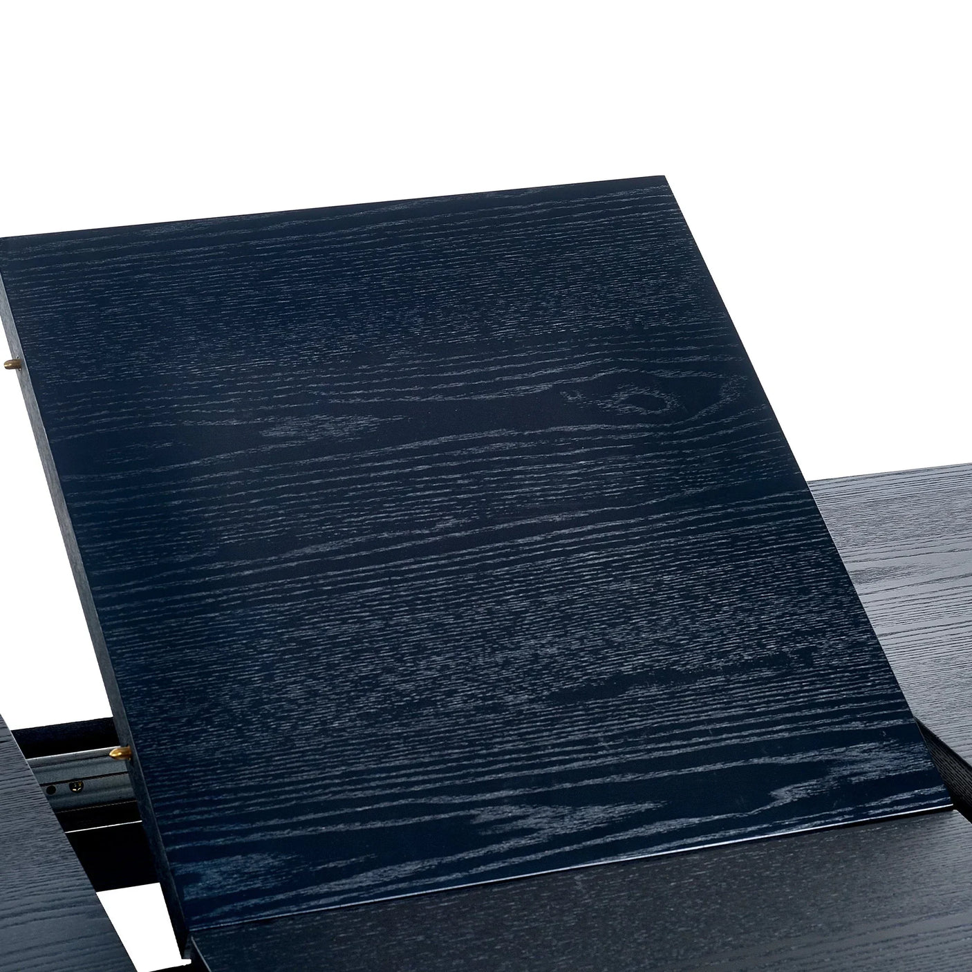 Black fluted extending dining table close-up showing wood grain and extension panel detail