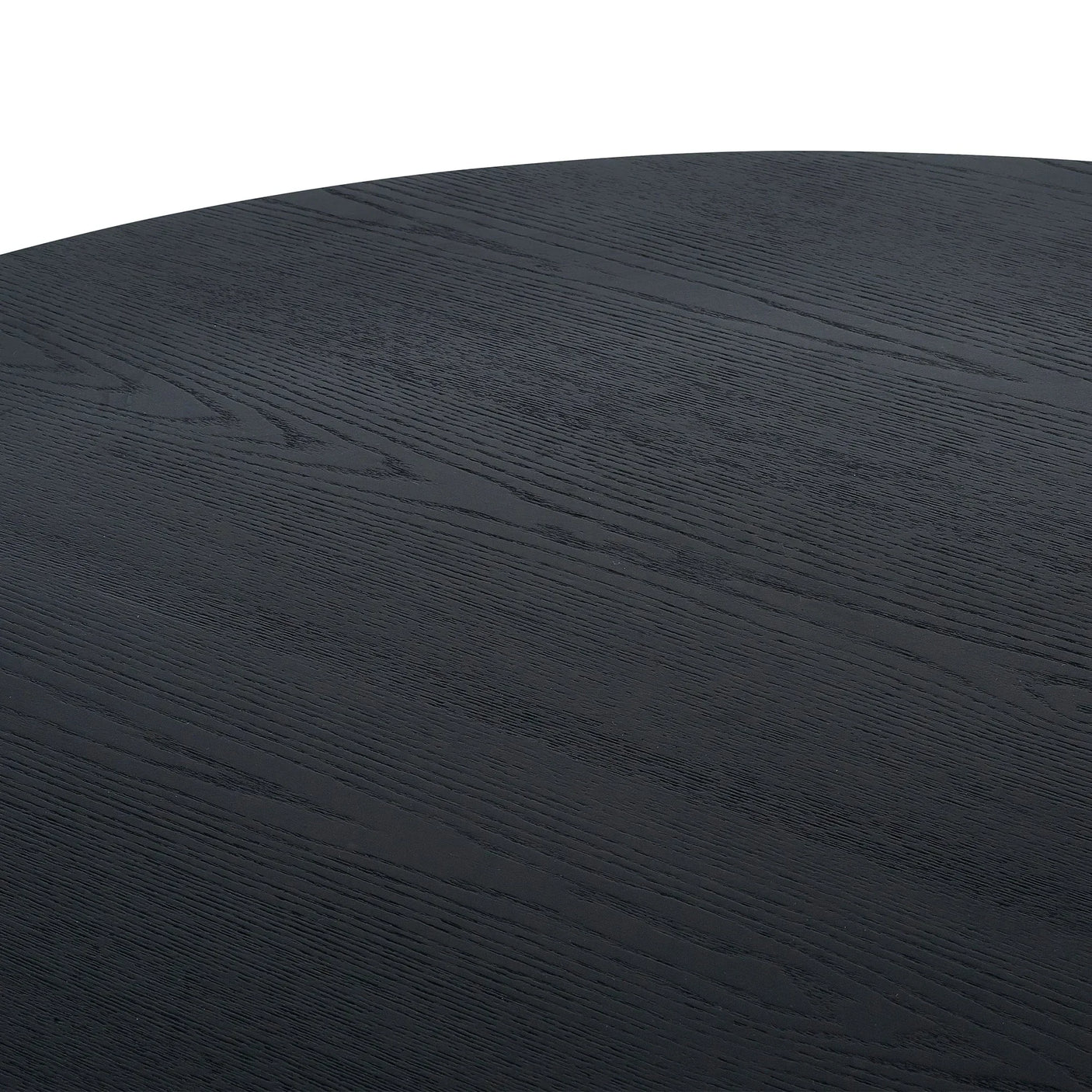 Black fluted round dining table top with visible wood grain texture