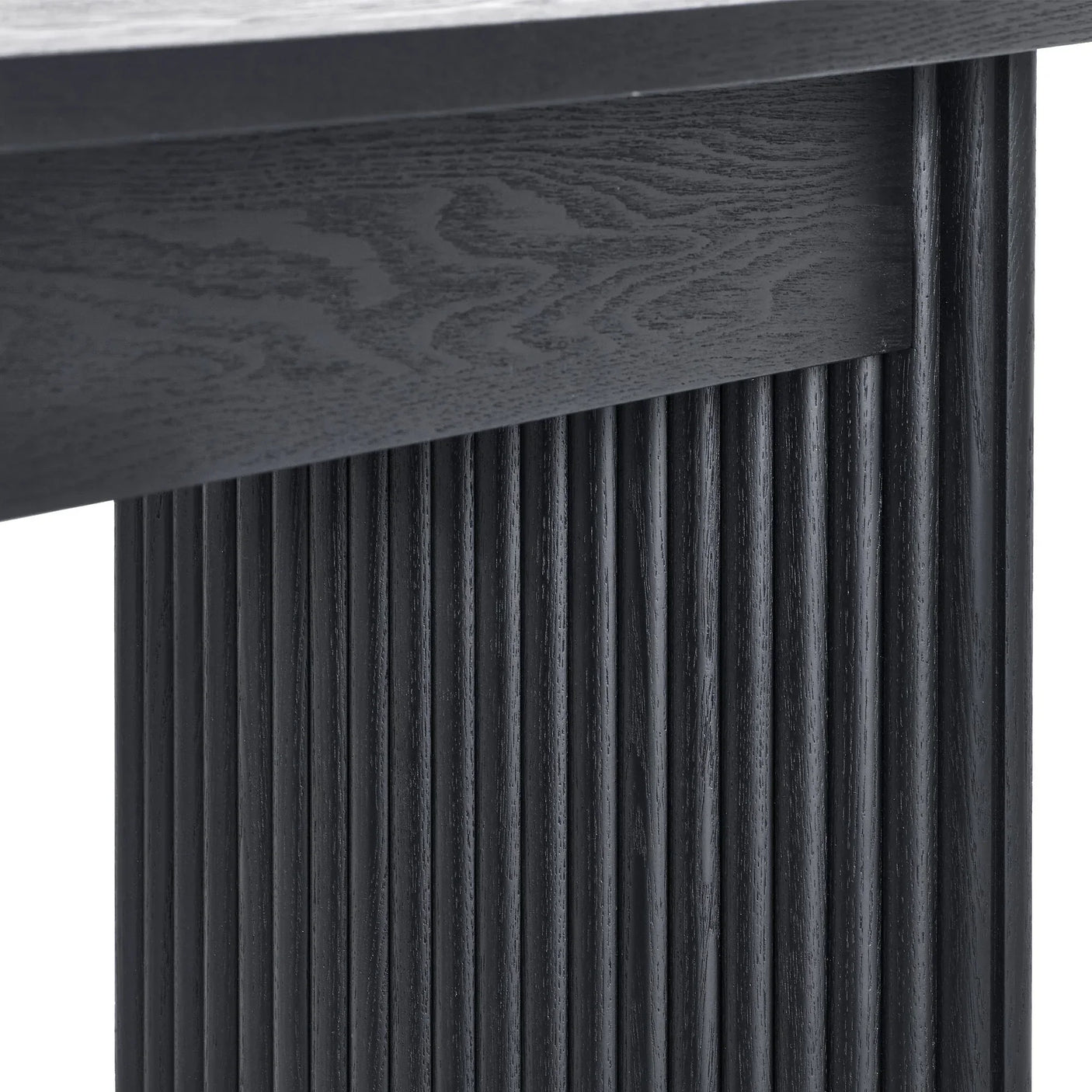 Black fluted compact coffee table closeup showing wood grain and textured vertical base