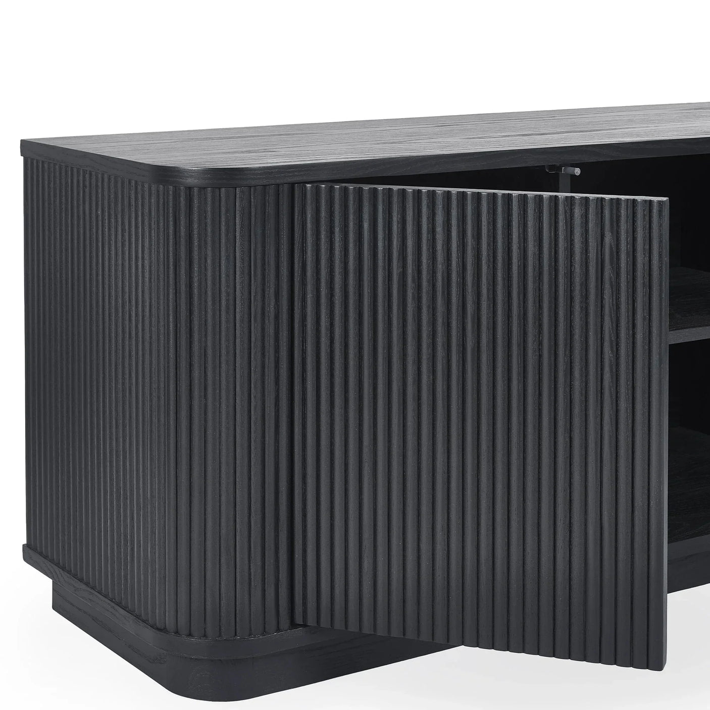 Black fluted TV unit close-up showing textured cabinet door and internal shelving