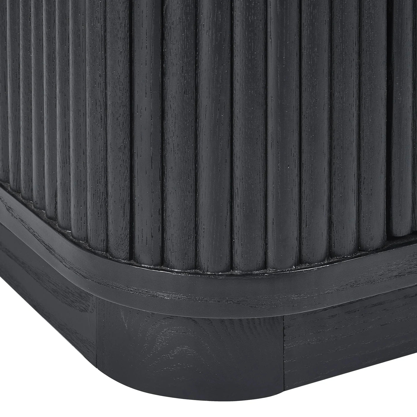 Close up of black fluted sideboard corner showing vertical wood grain detail