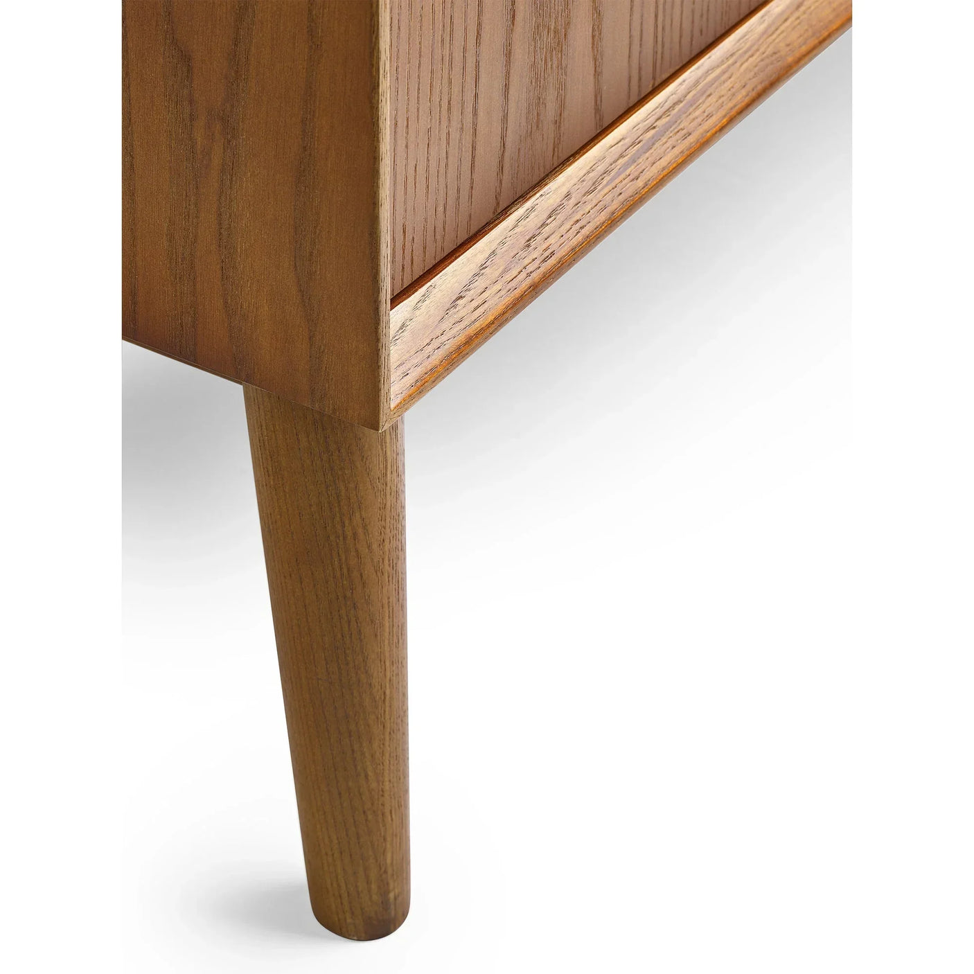 Close-up of wooden sideboard leg and corner detail in natural oak finish