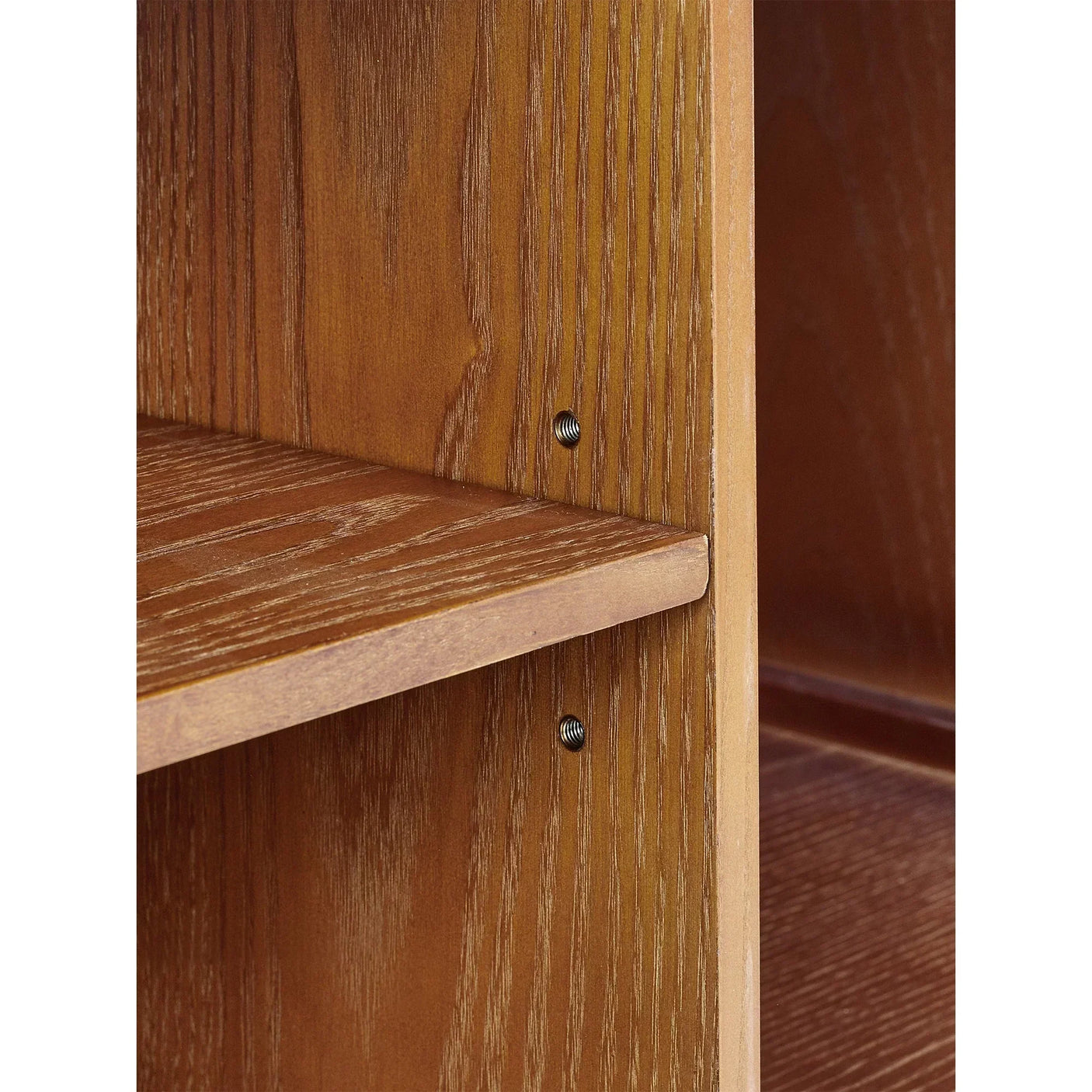 Closeup of oak media unit shelf showing wood grain and metal fixings