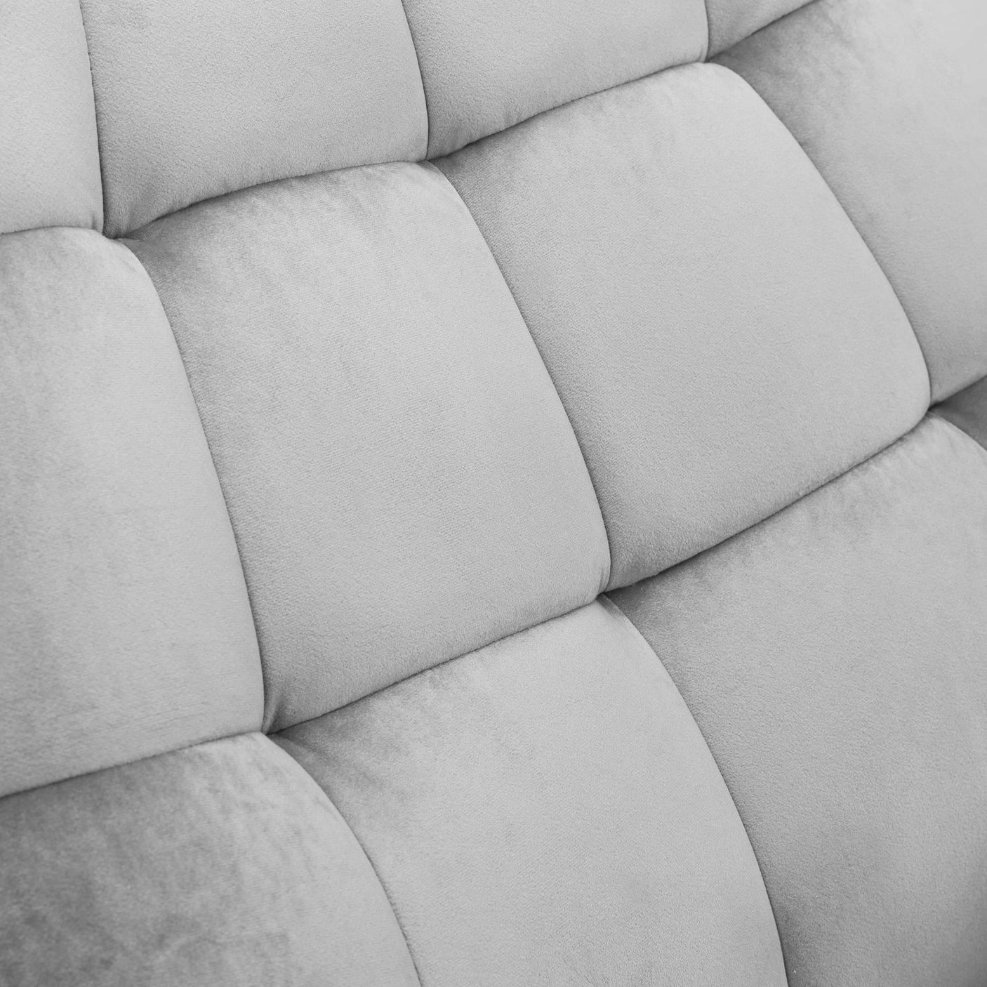 Close-up of velvet chair upholstery showing soft grey padded detail
