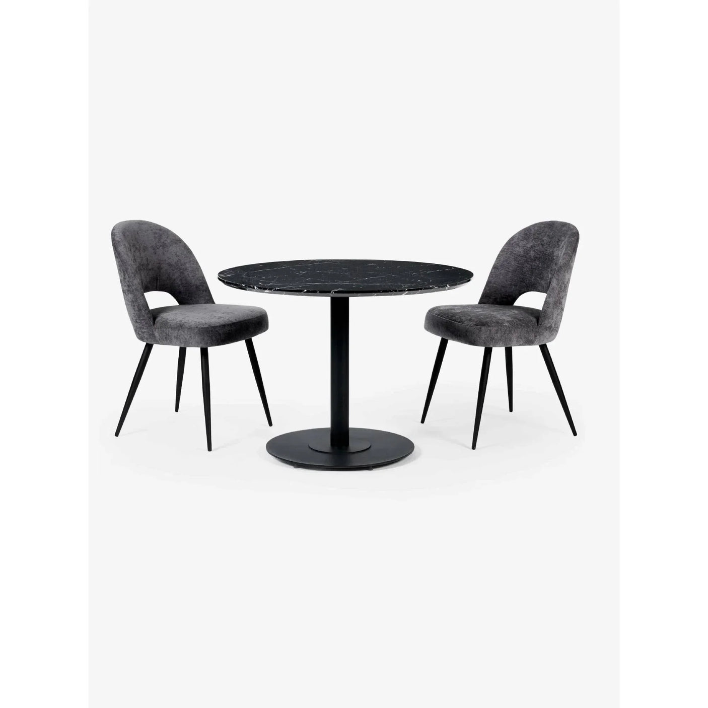 Round black marble dining table with two grey velvet dining chairs on white background