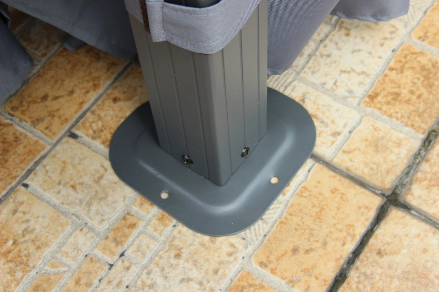 Powder coated steel gazebo leg base secured to patio tiles