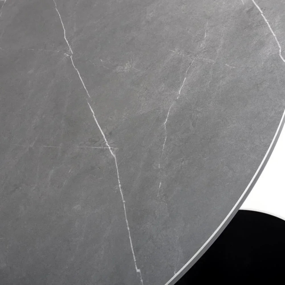 Round grey marble dining table top with subtle white veining, close-up view