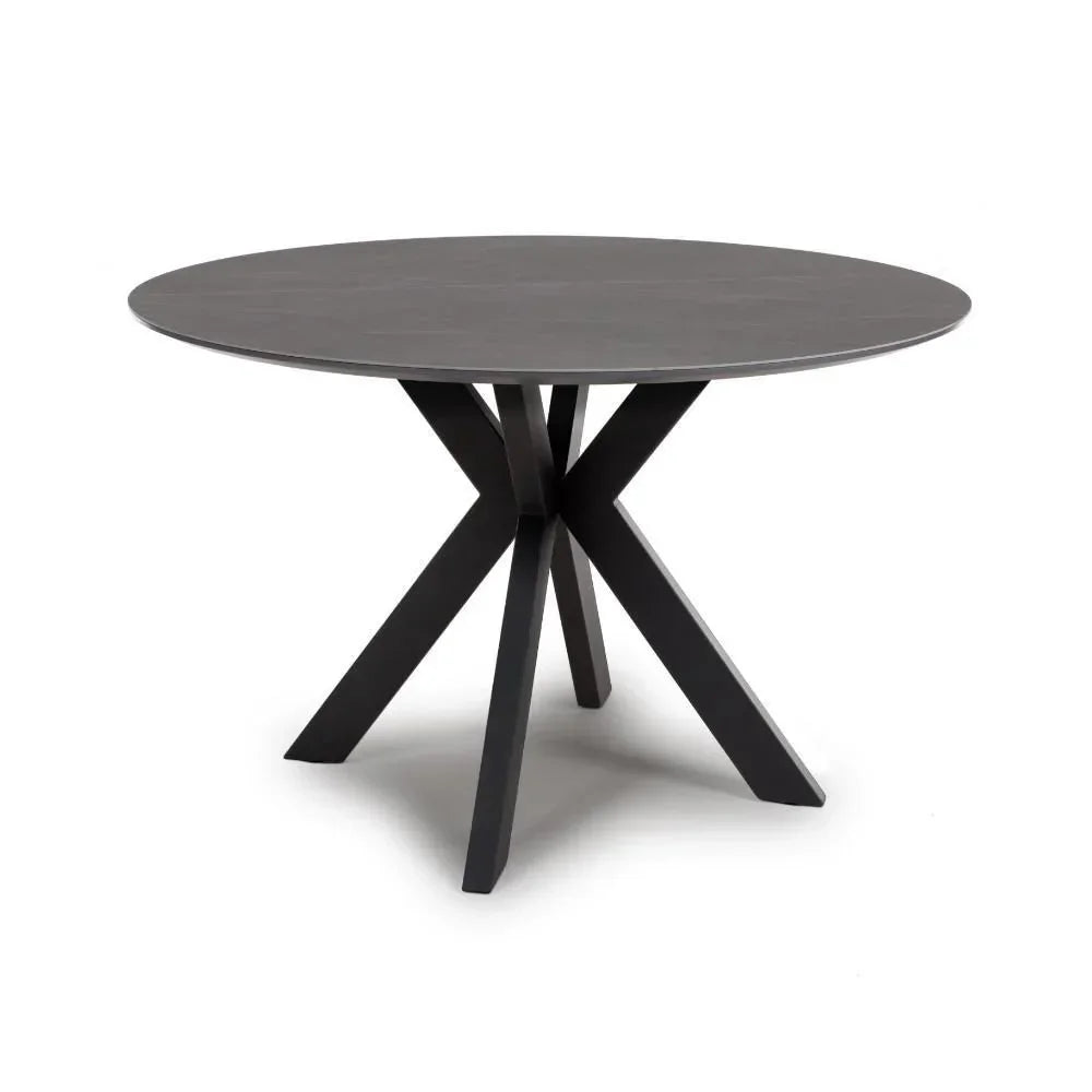 Round dining table with dark wood top and black angular metal legs