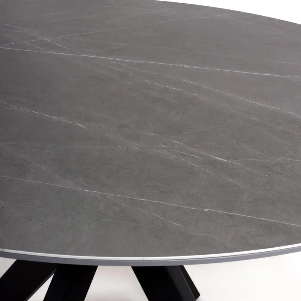 Round grey stone dining table top with subtle veining and black angled legs