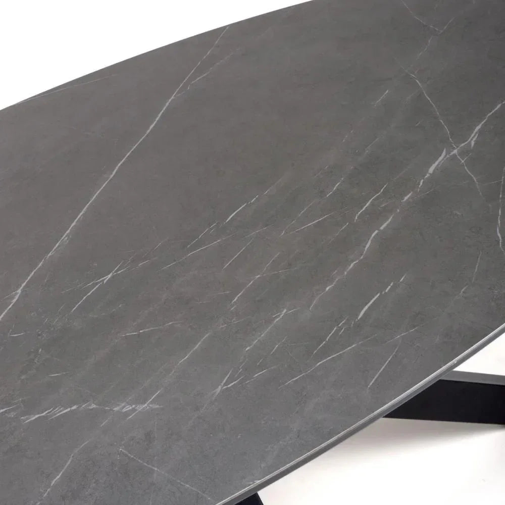 Close-up of grey marble effect dining table top with subtle white veining and black legs